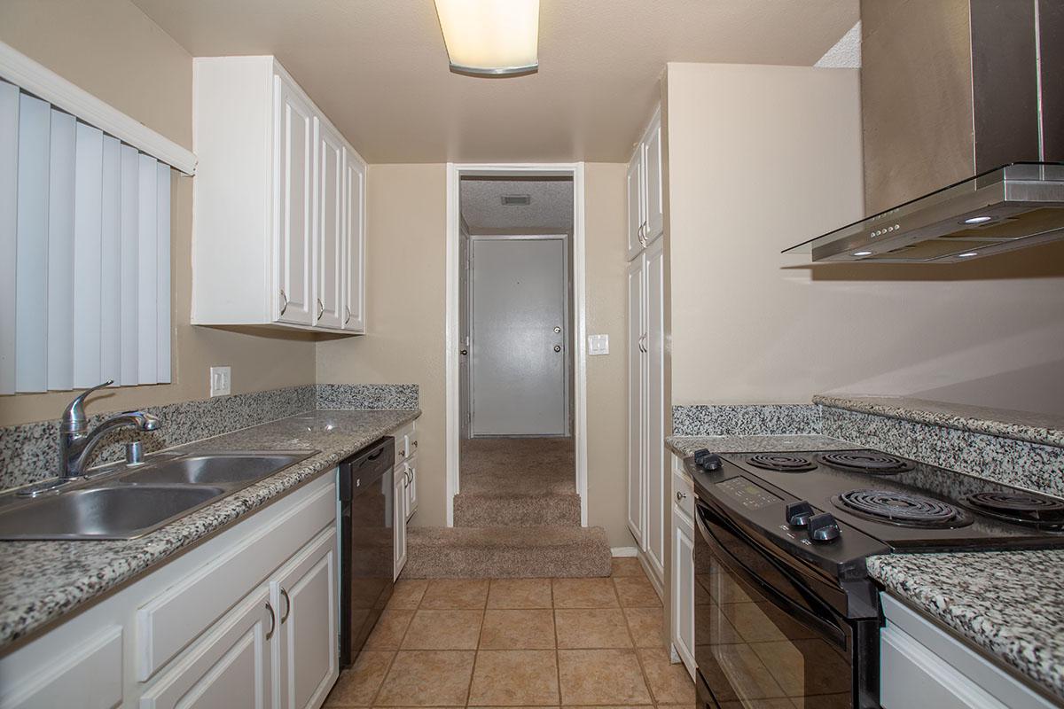 a kitchen with a stove and a sink