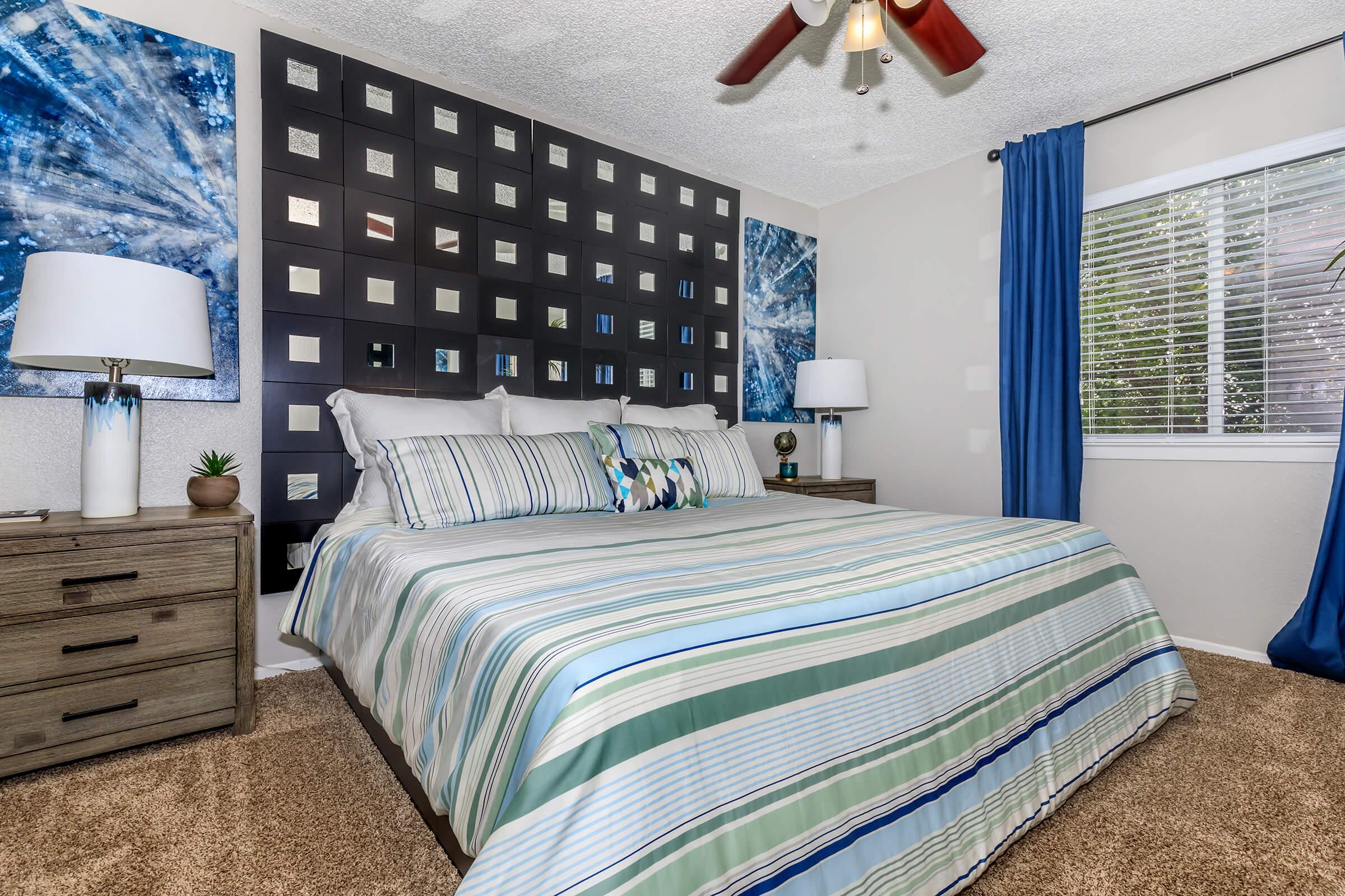 a bedroom with a bed and desk in a room