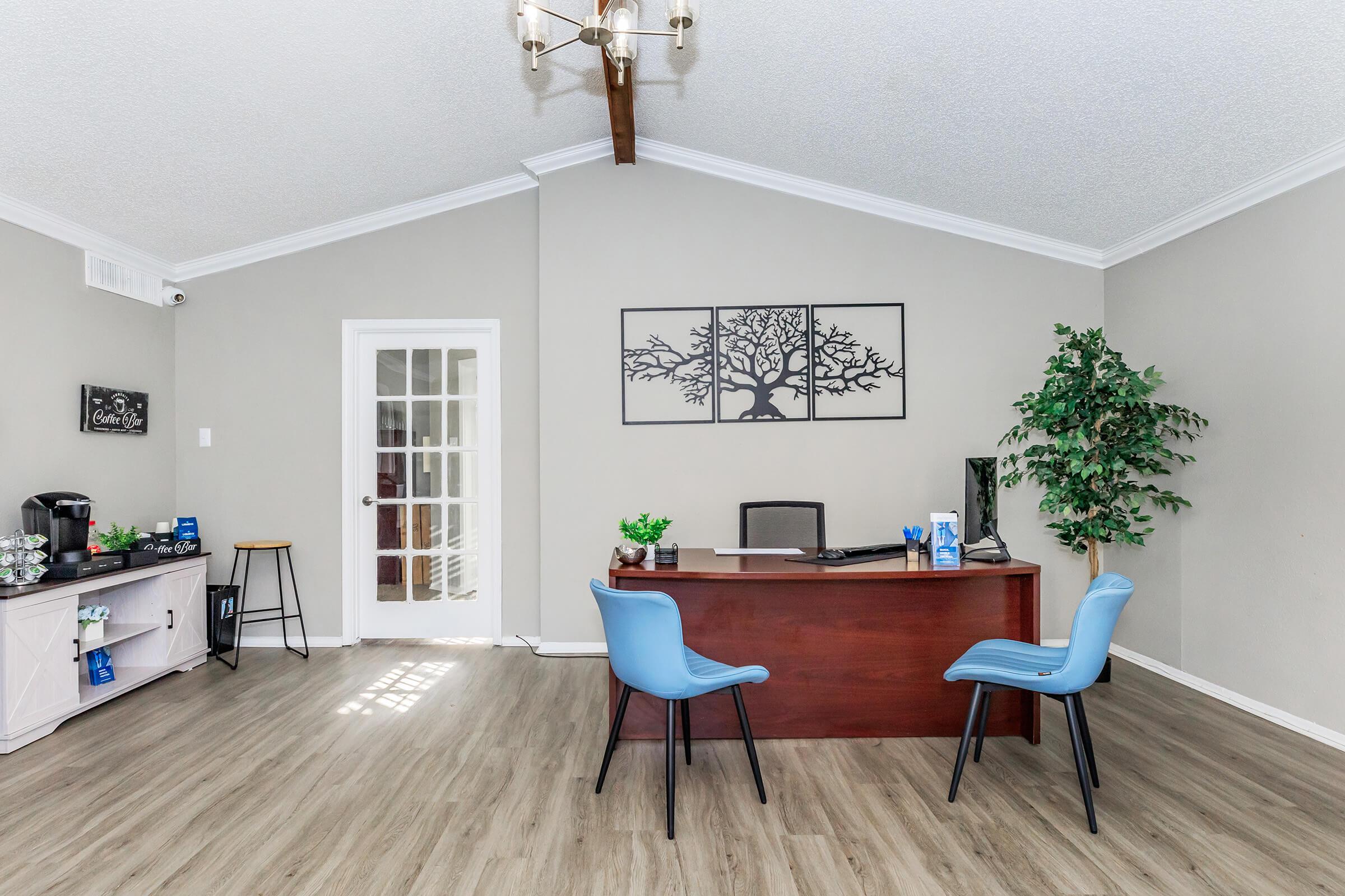 a living room filled with furniture on top of a hard wood floor