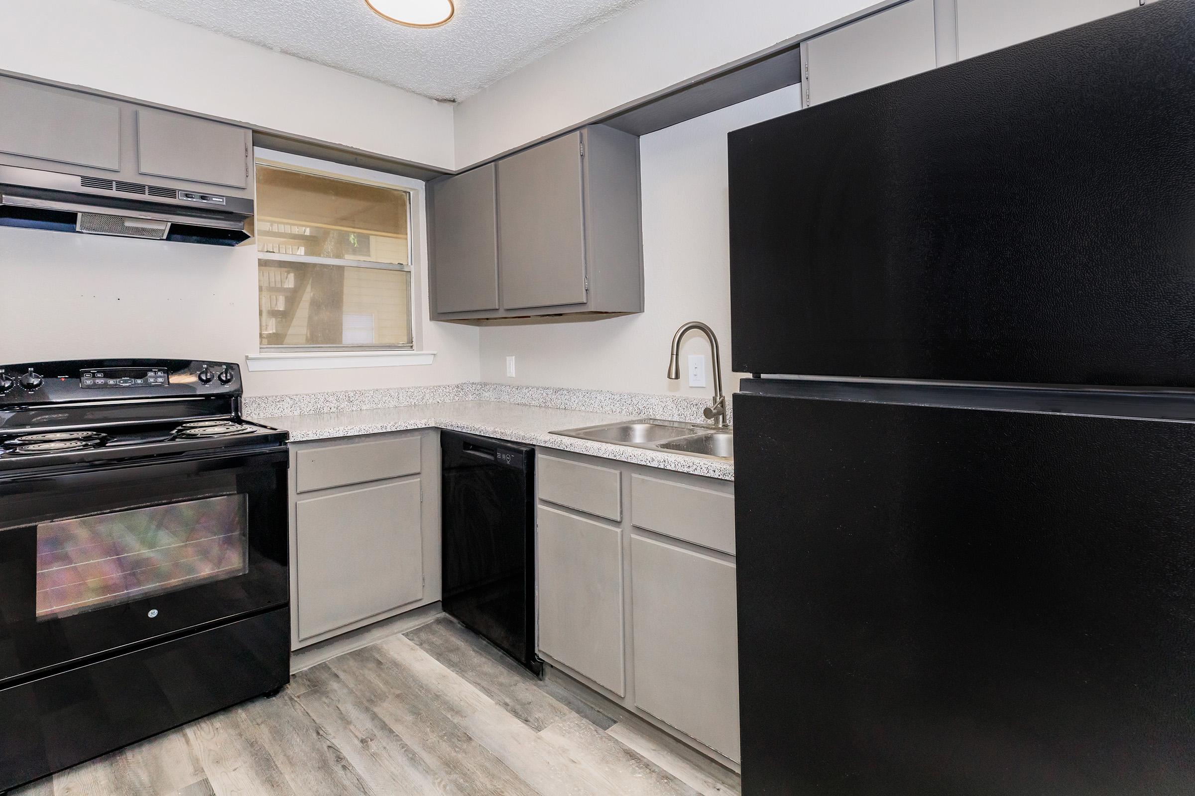 a stove top oven sitting inside of a kitchen