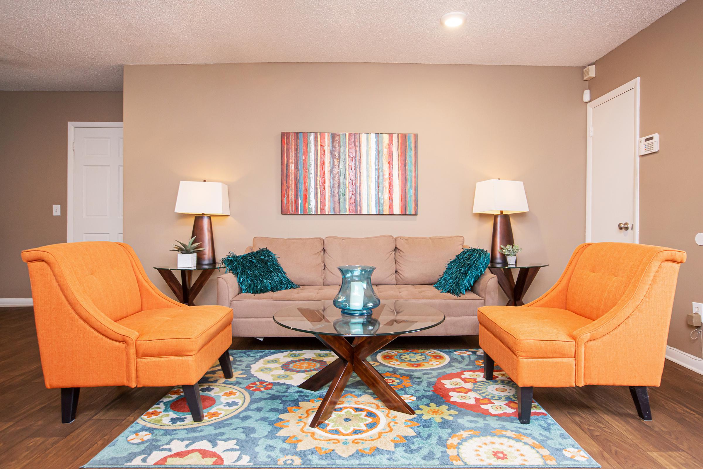 a living room filled with furniture and a lamp