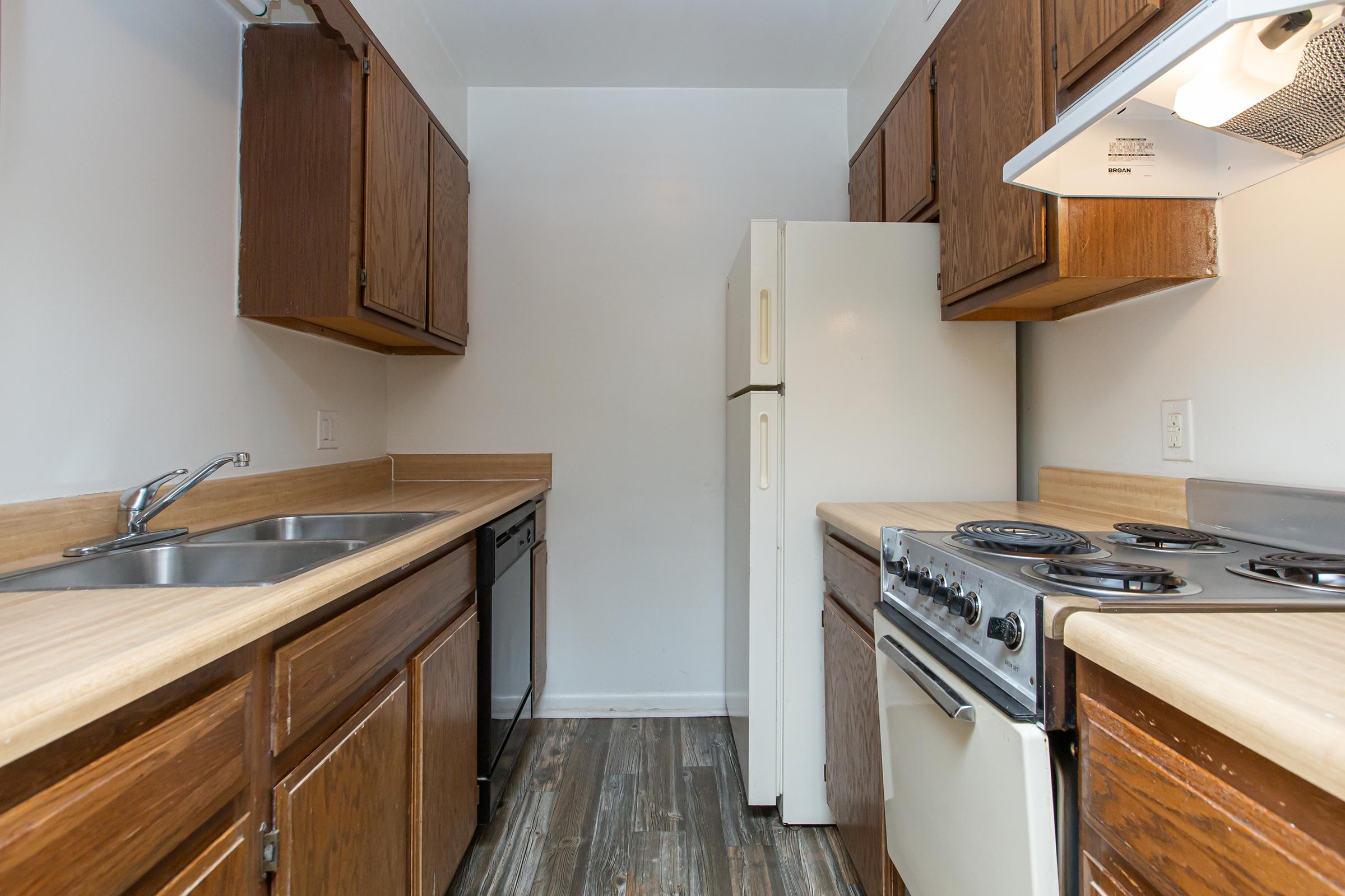 a kitchen with a stove sink and refrigerator