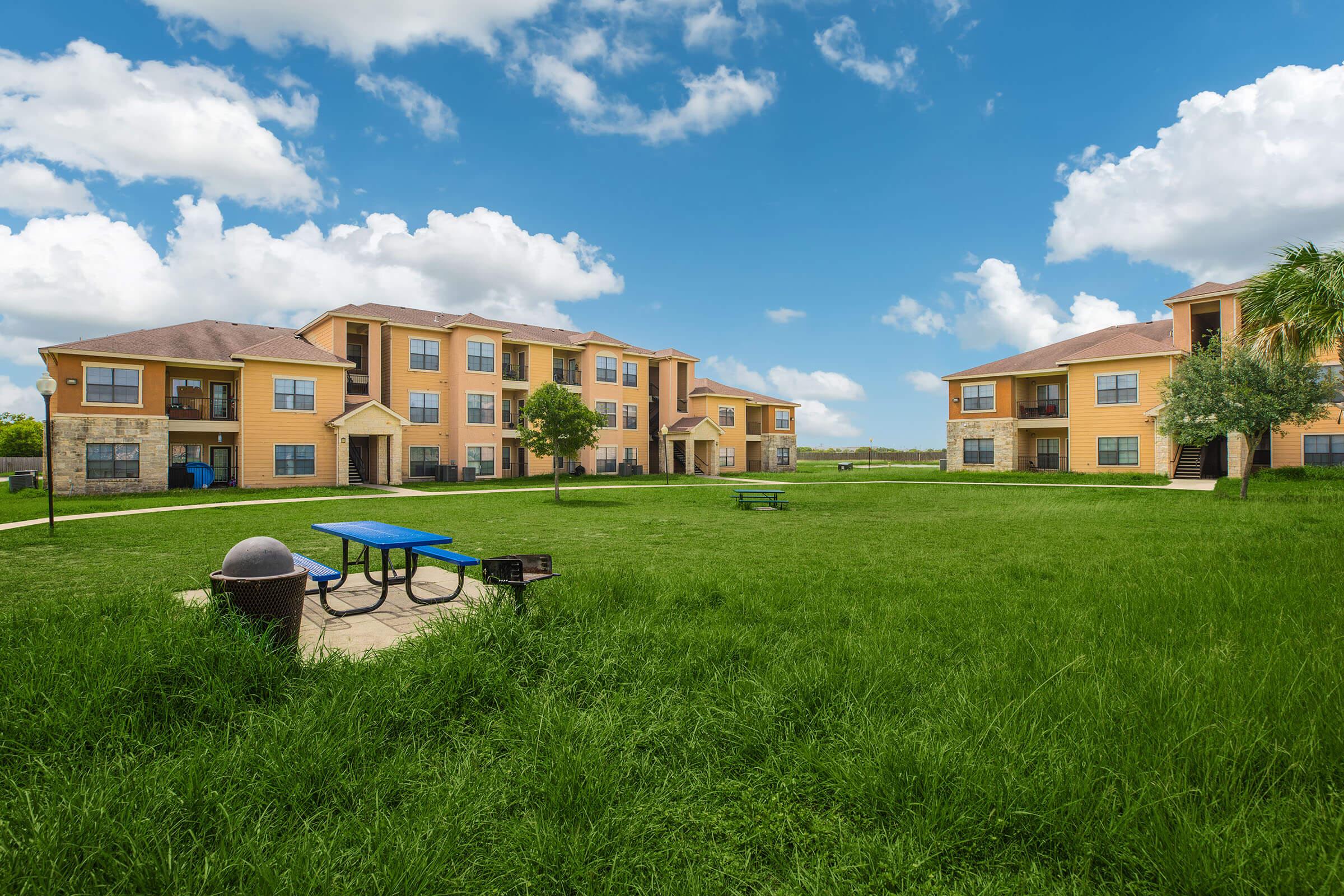 a group of lawn chairs sitting on top of a grass covered field