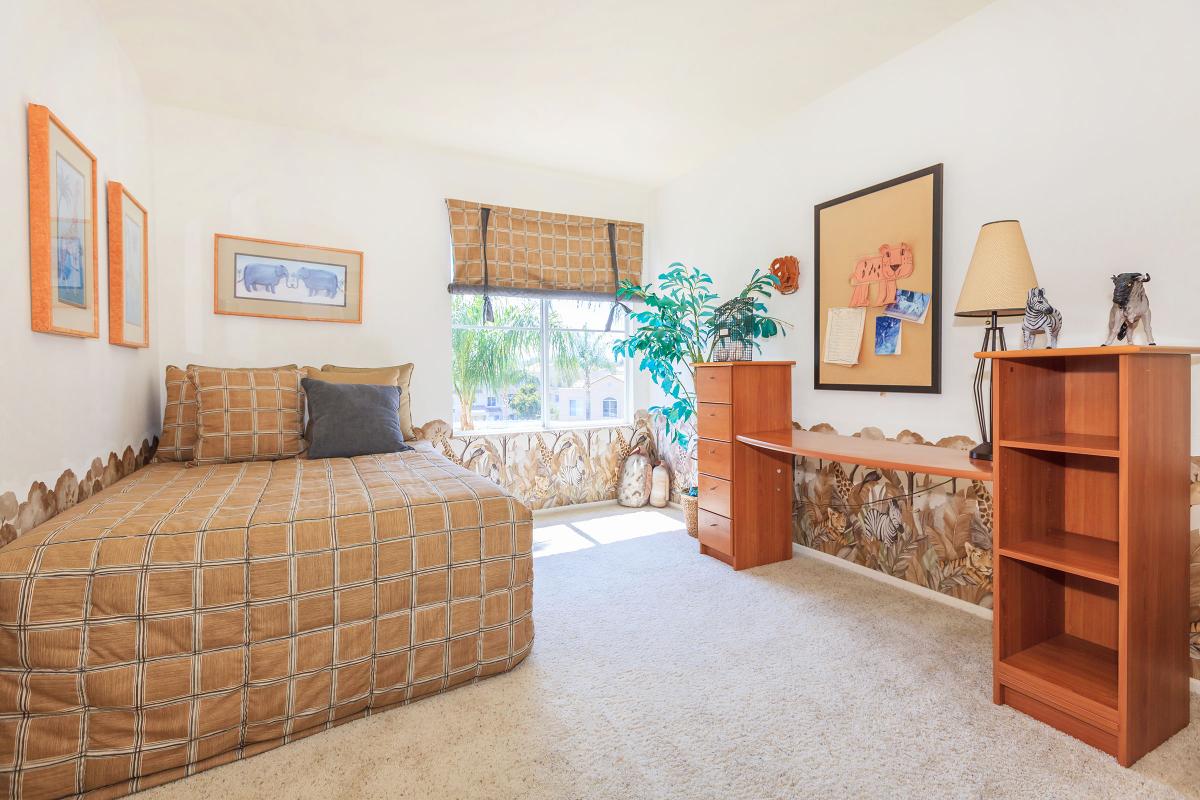 a bedroom with a bed in a room