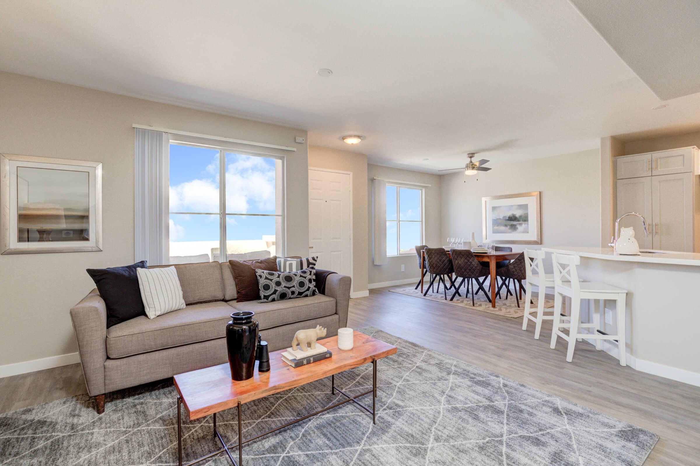 a living room filled with furniture and a large window