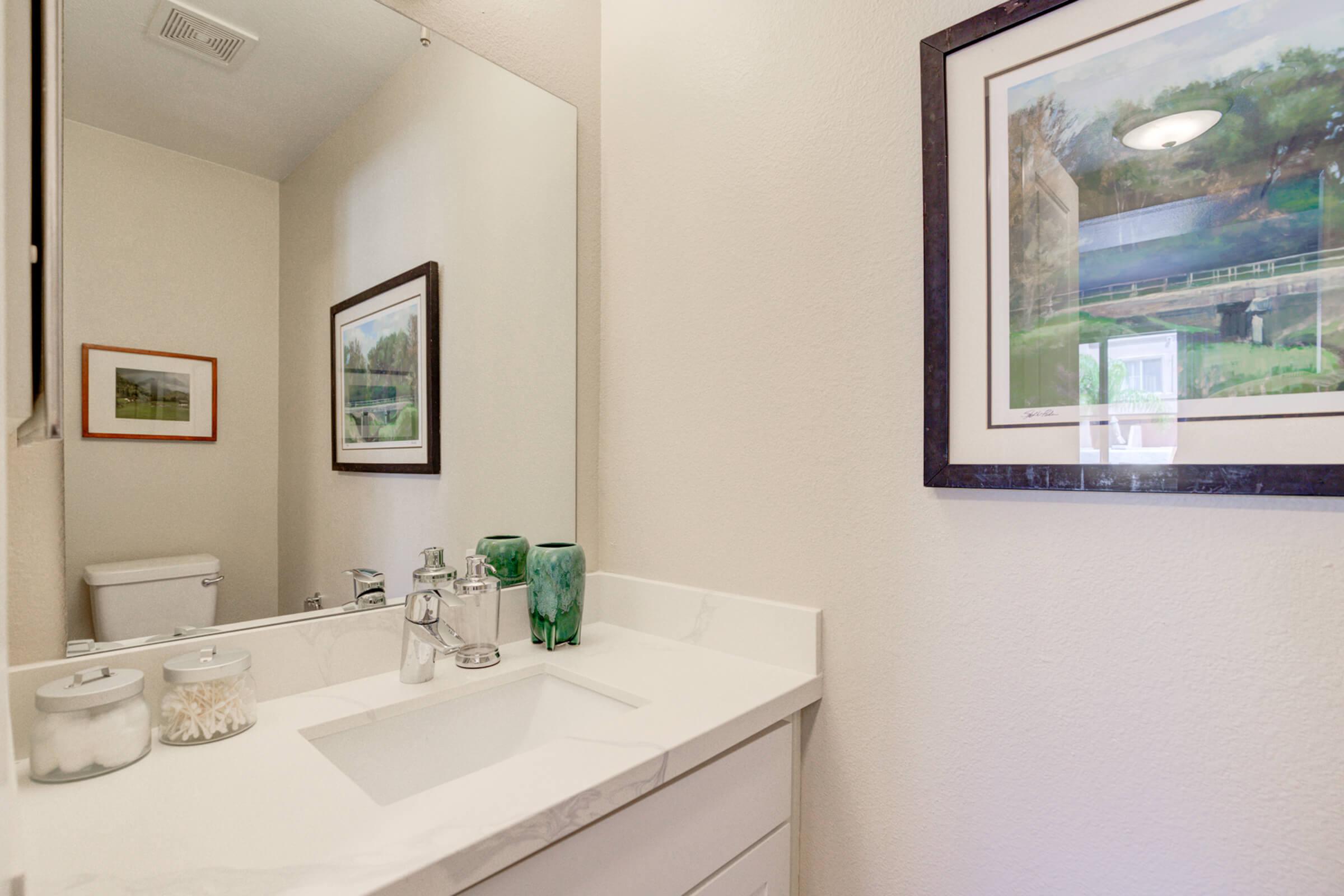 a room with a sink and a mirror