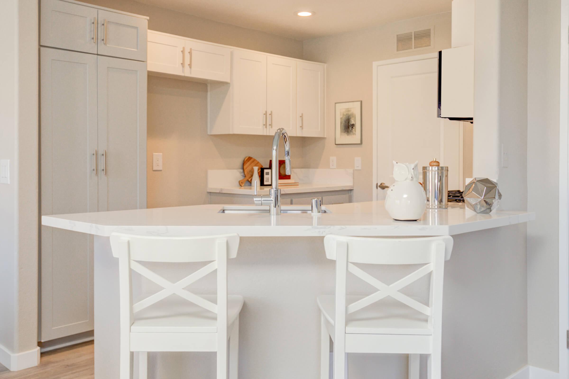 a kitchen with a sink and a mirror