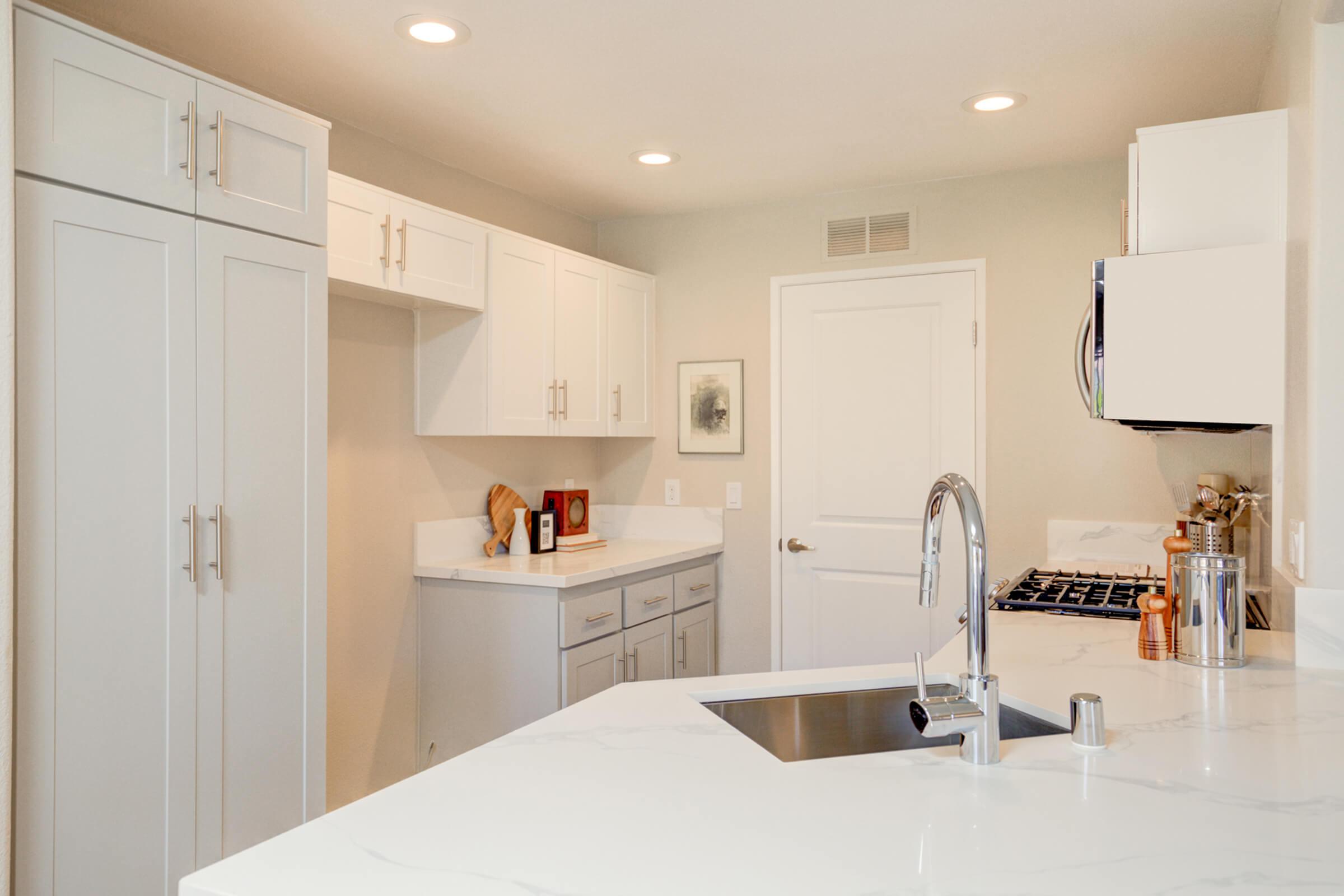 a kitchen with a sink and a refrigerator