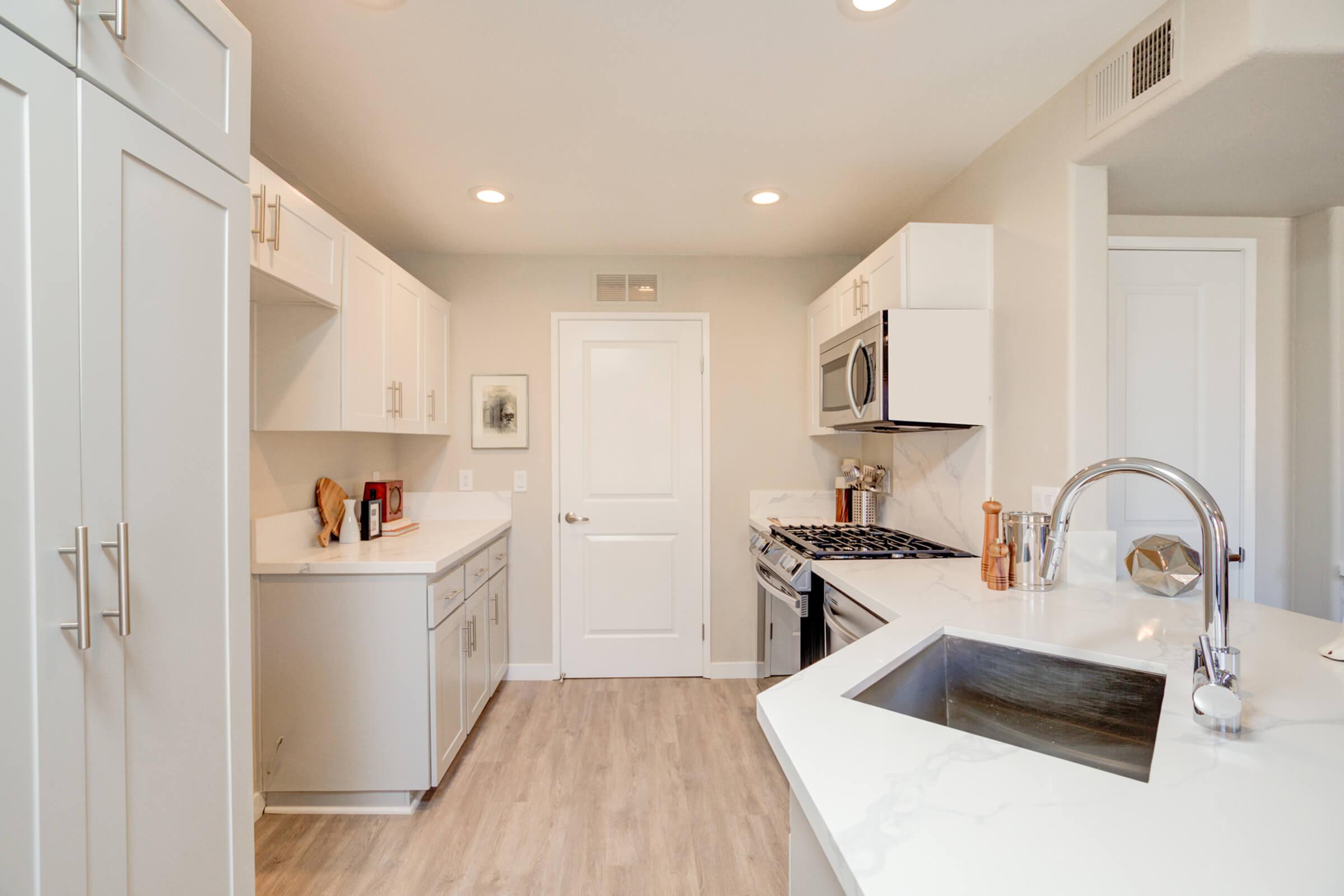 a kitchen with a sink and a refrigerator