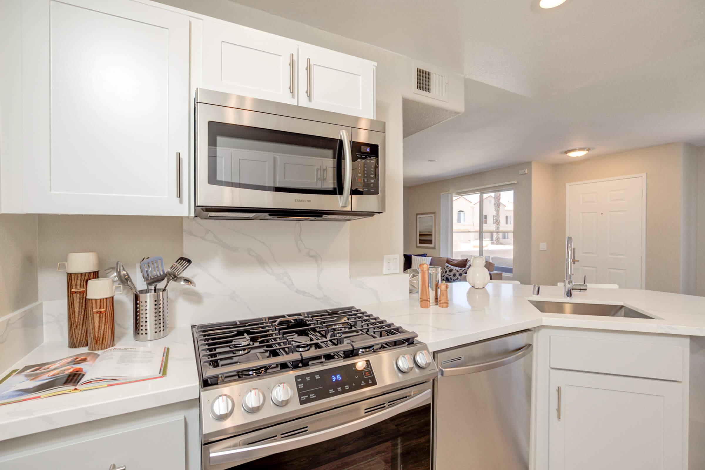 a stove top oven sitting inside of a kitchen