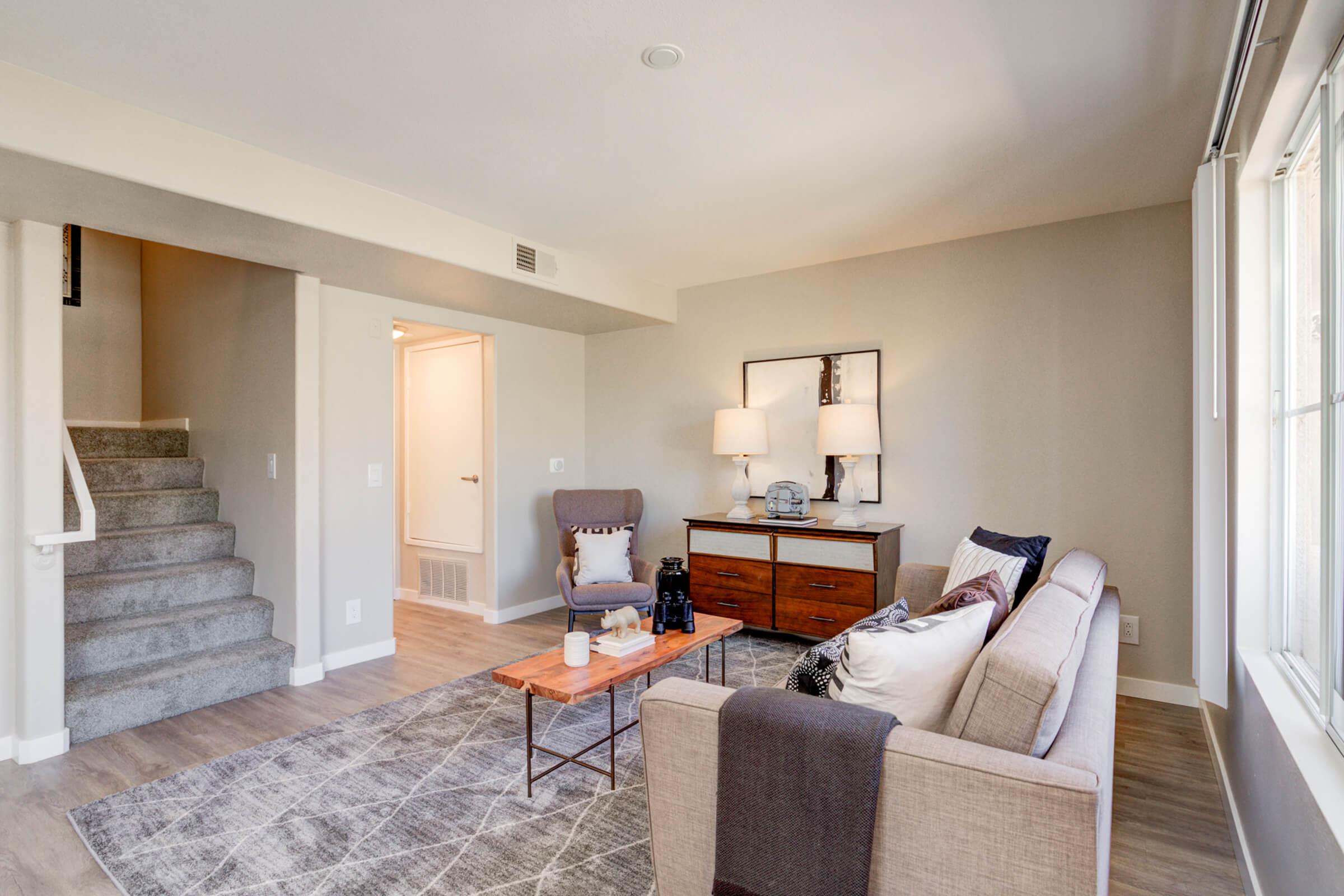 a living room filled with furniture and a fireplace