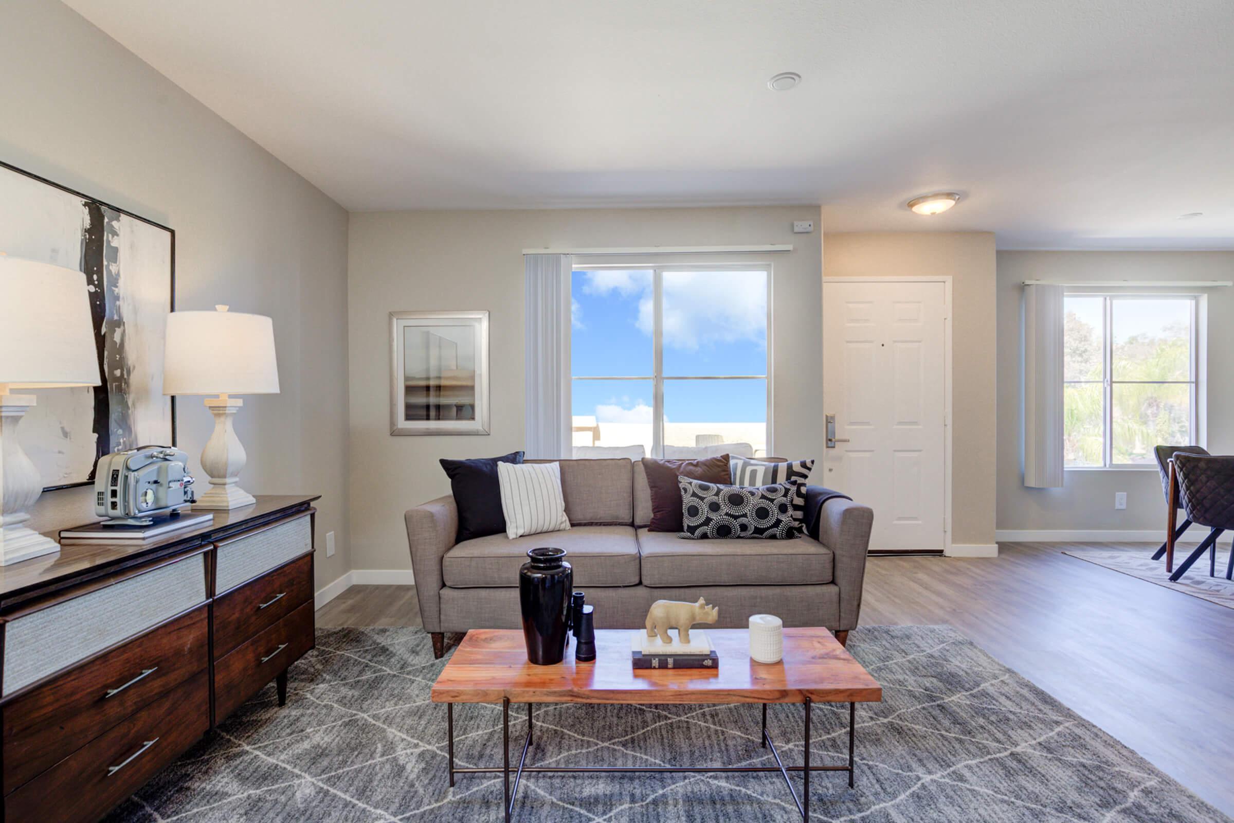 a living room filled with furniture and a large window