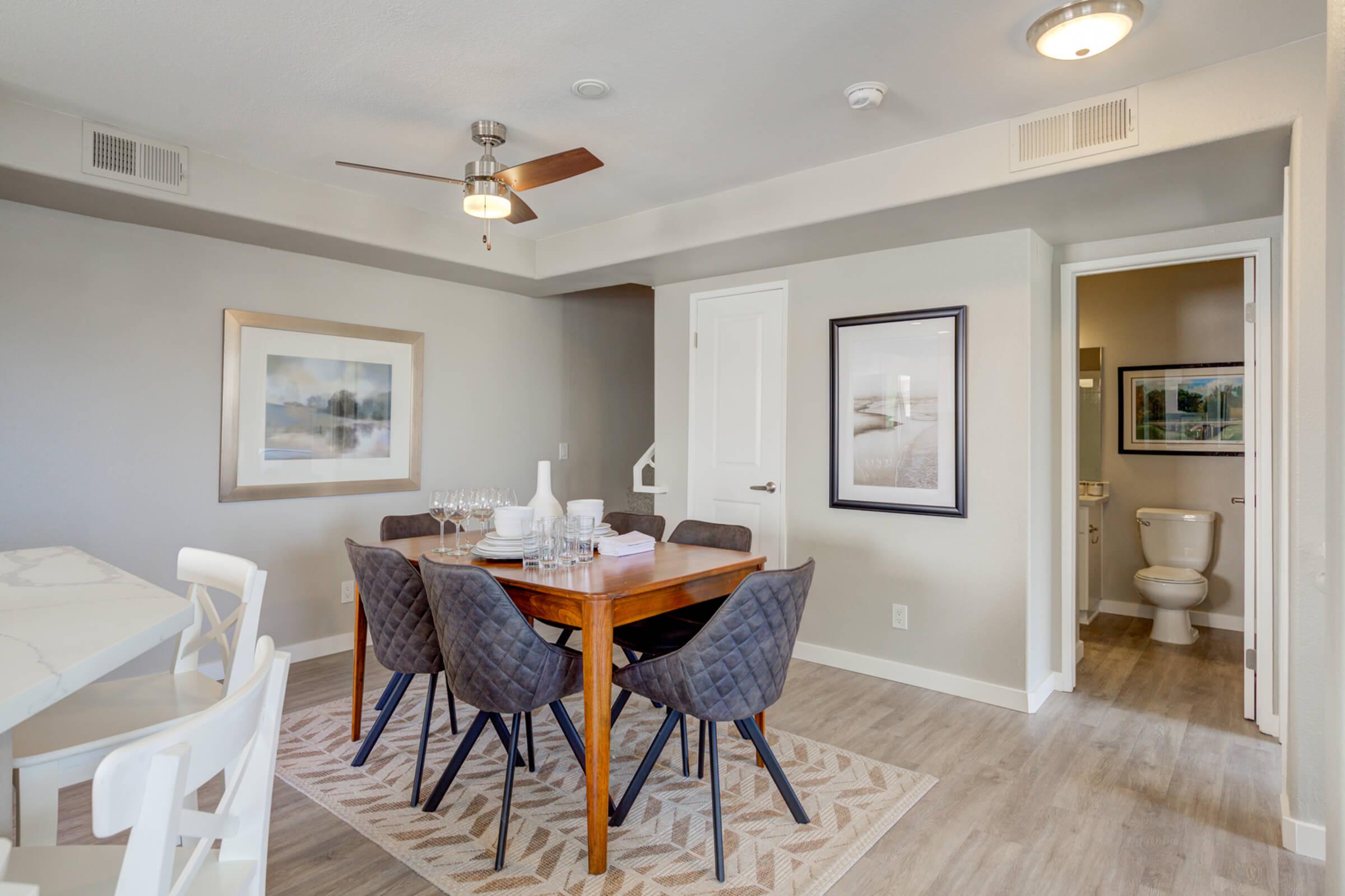 a living room filled with furniture and a large mirror