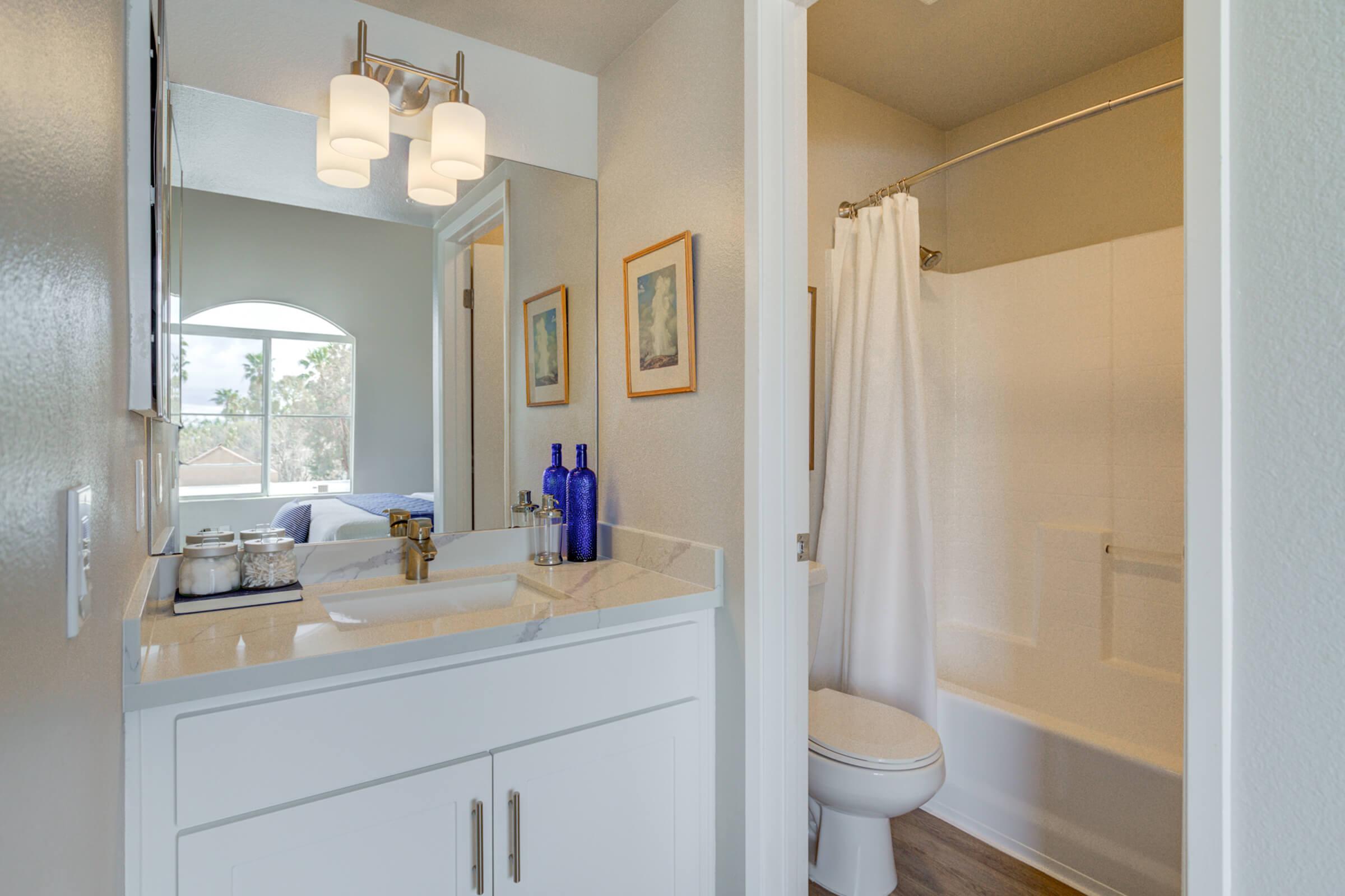 a kitchen with a sink and a mirror