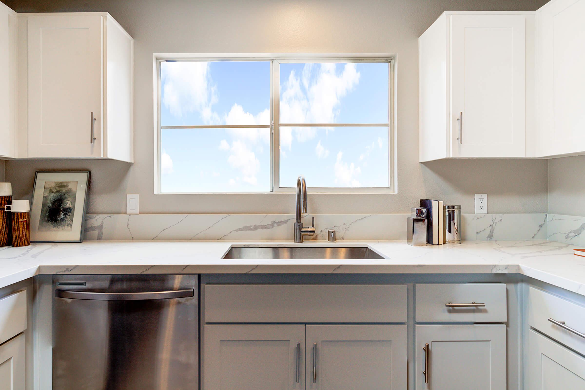 a kitchen with a sink and a window