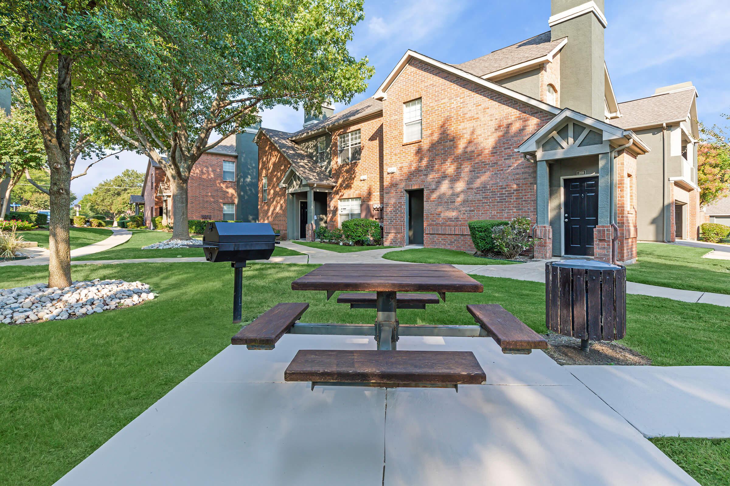 a barbecue and picnic table