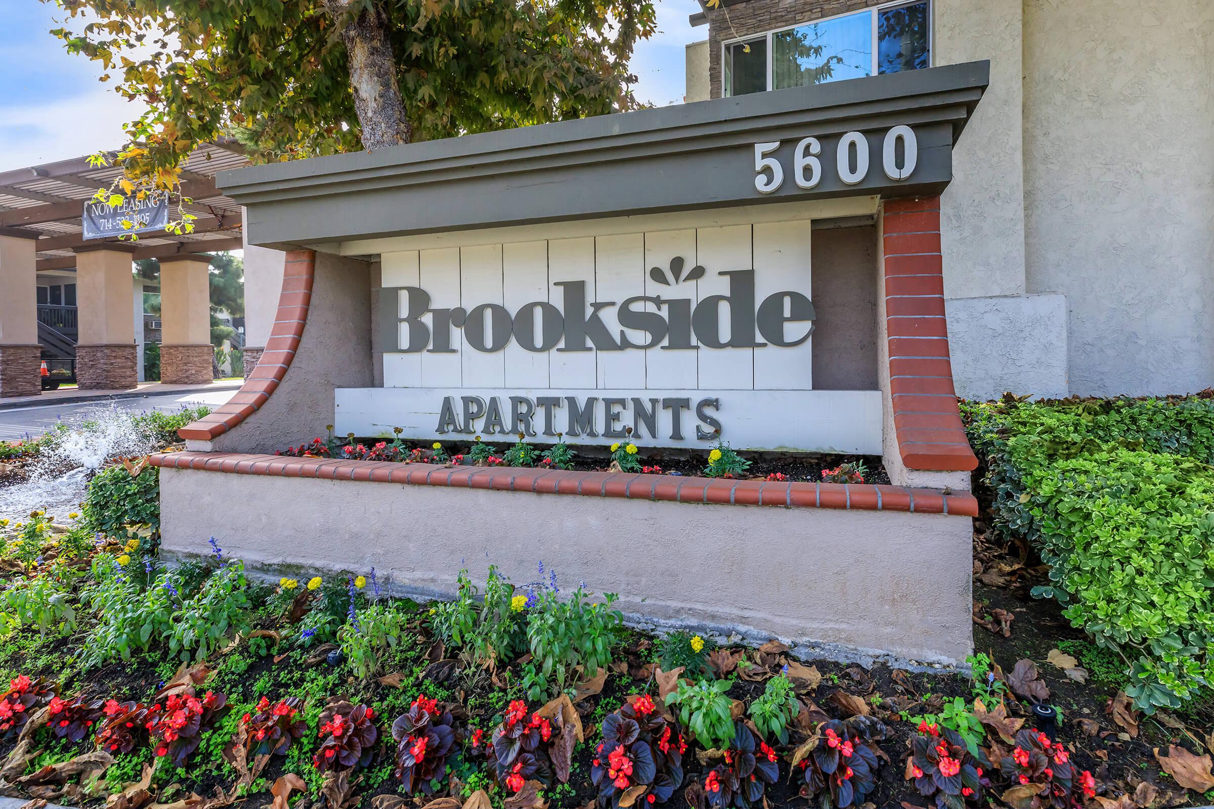 Brookside Apartments monument sign with flowers
