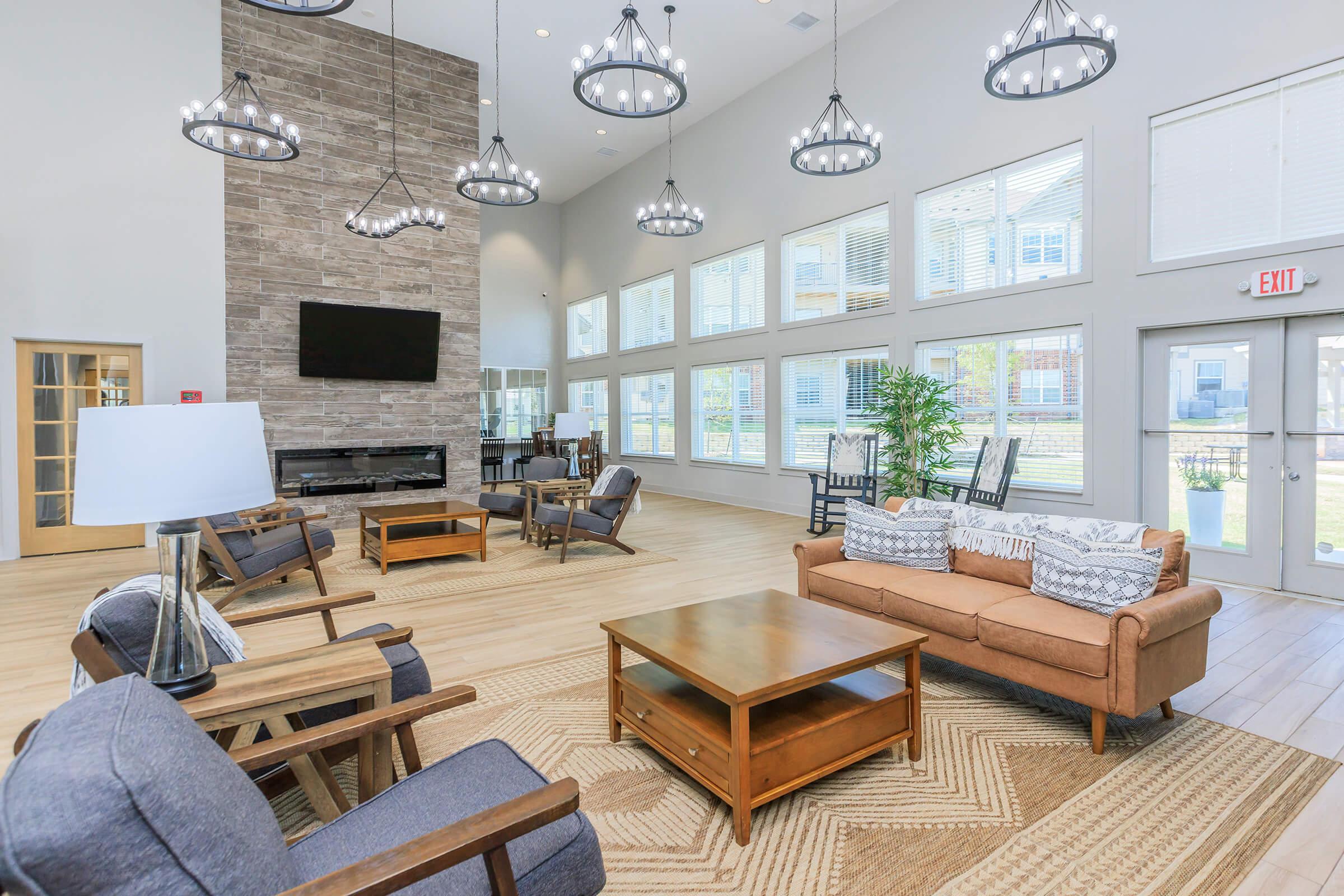 a living room filled with furniture and a large window