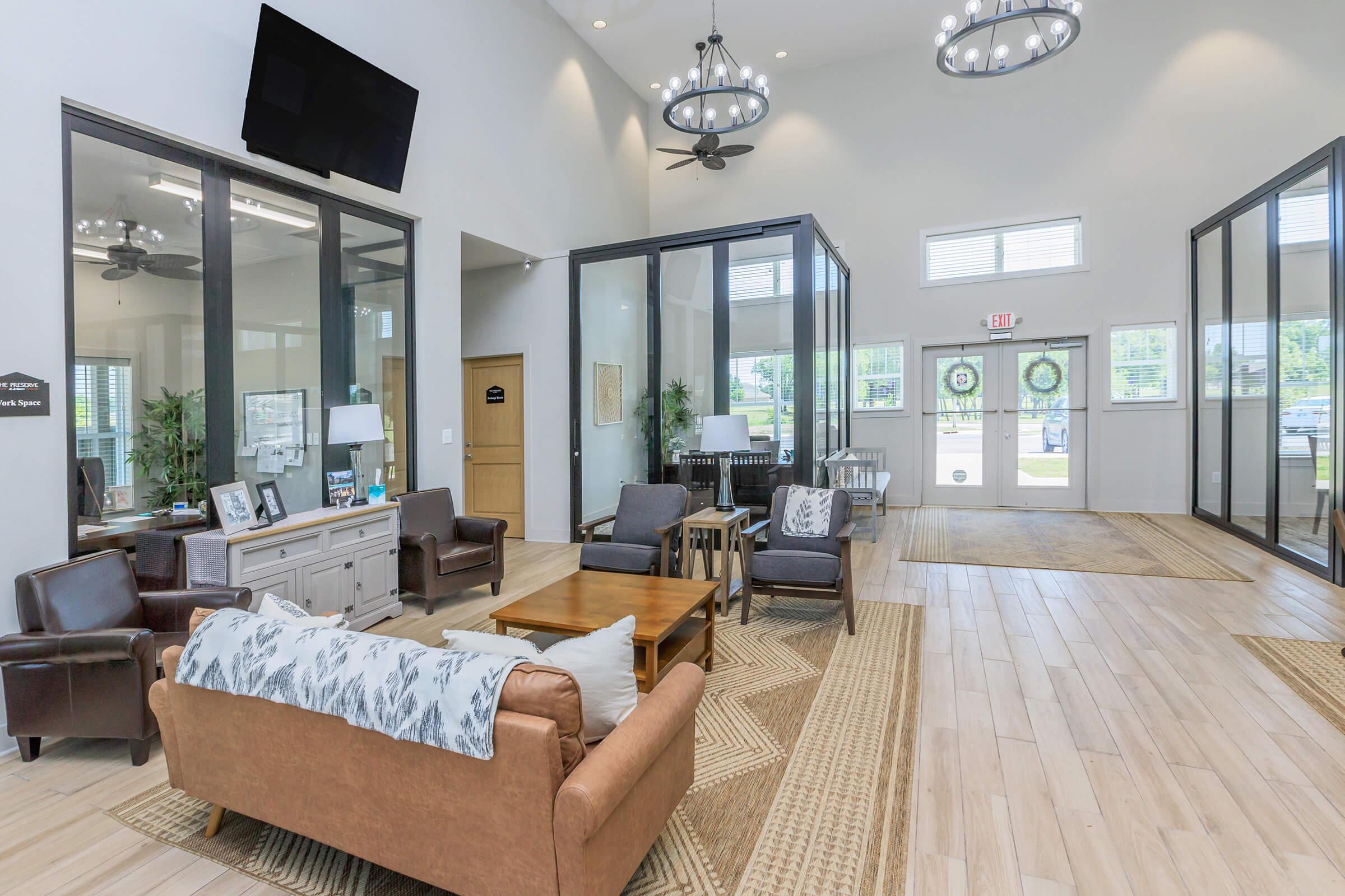 a living room filled with furniture and a large window