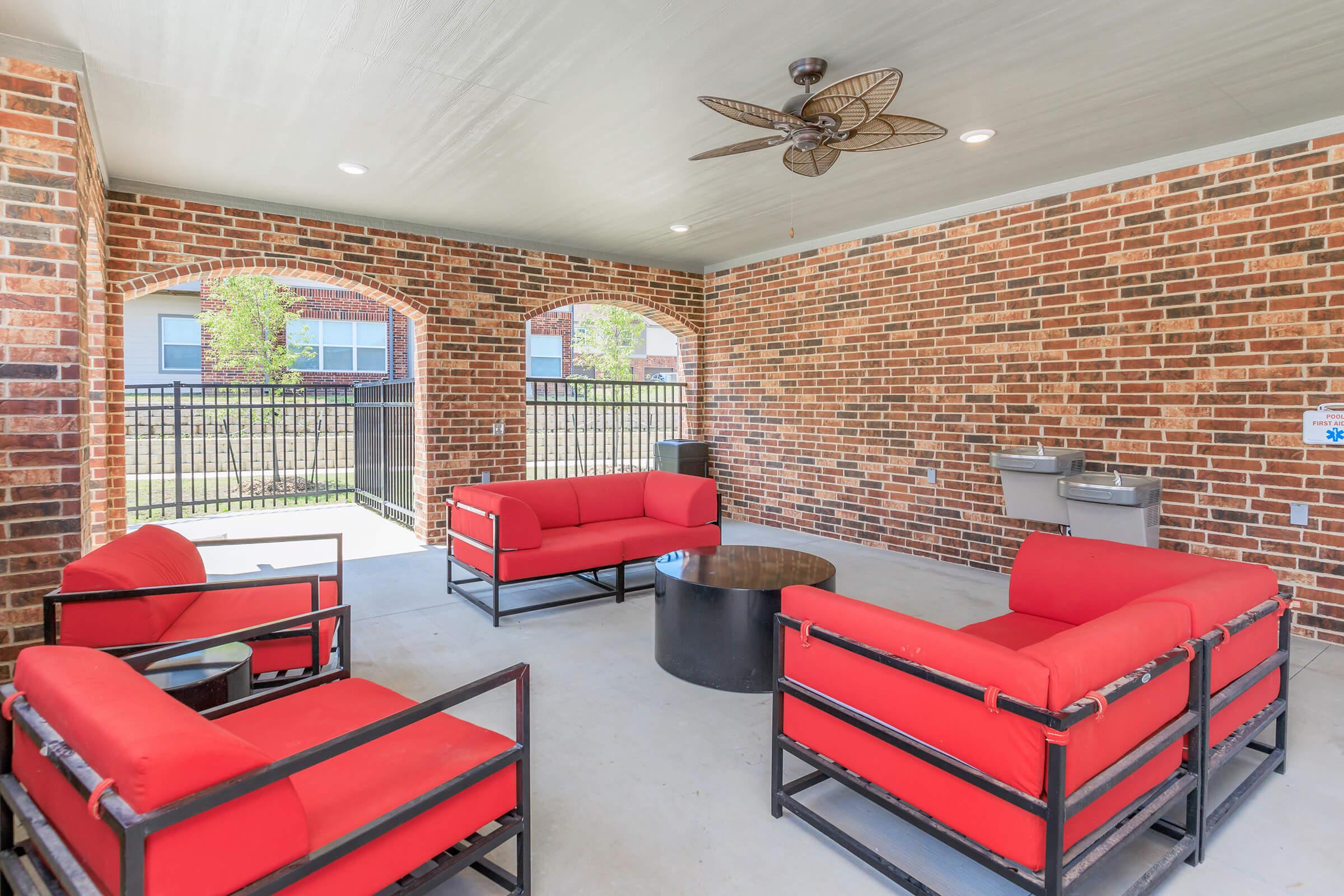 a living room filled with furniture and a brick building