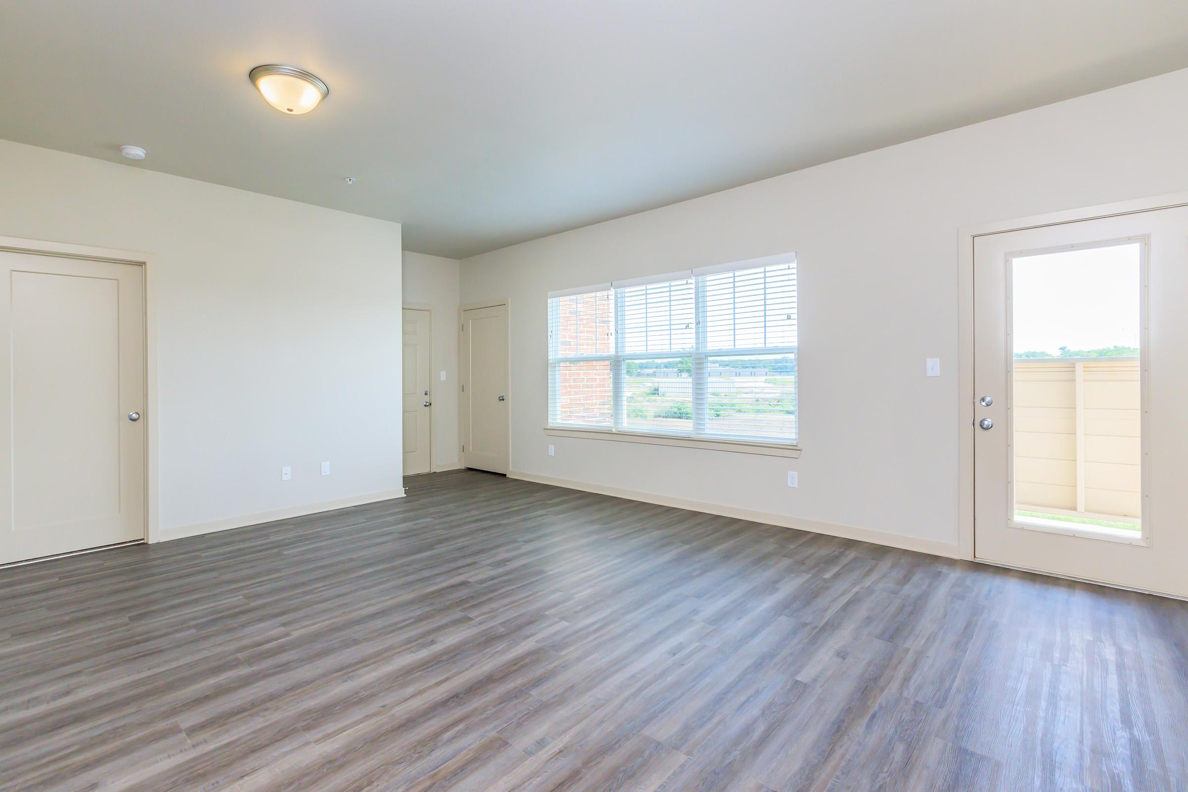 a large empty room with a wood floor