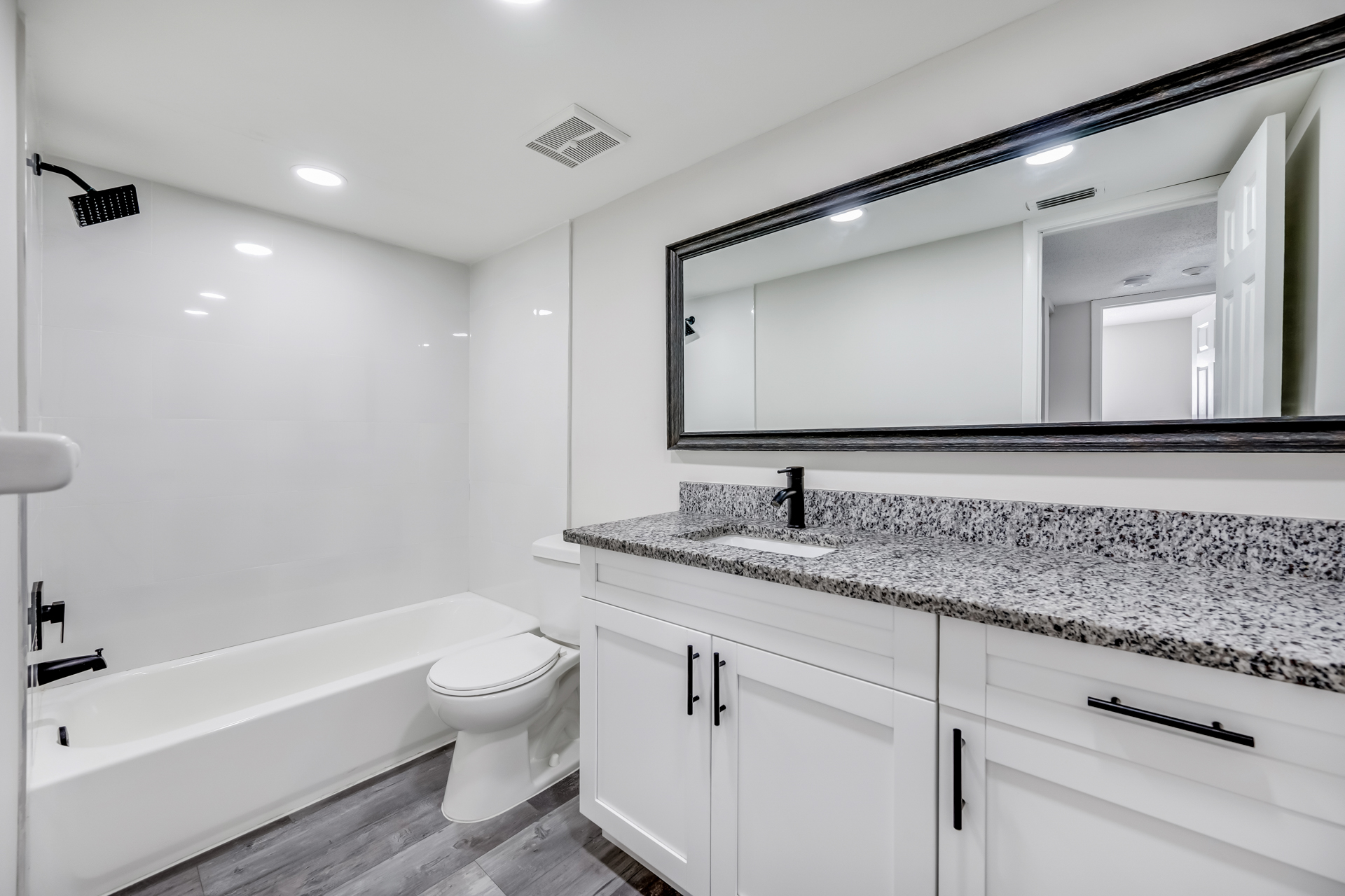 a kitchen with a sink and a mirror