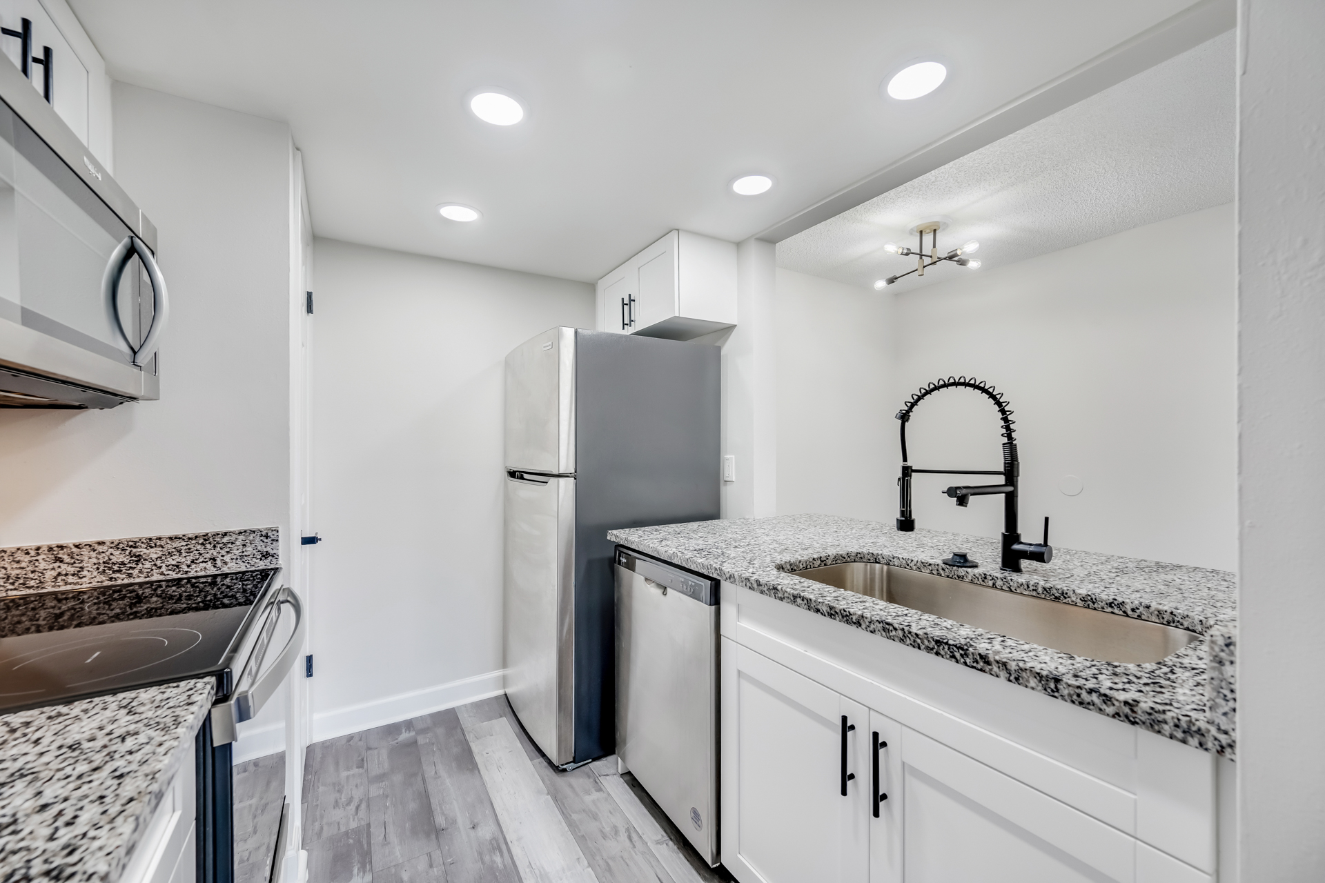 a kitchen with a sink and a mirror