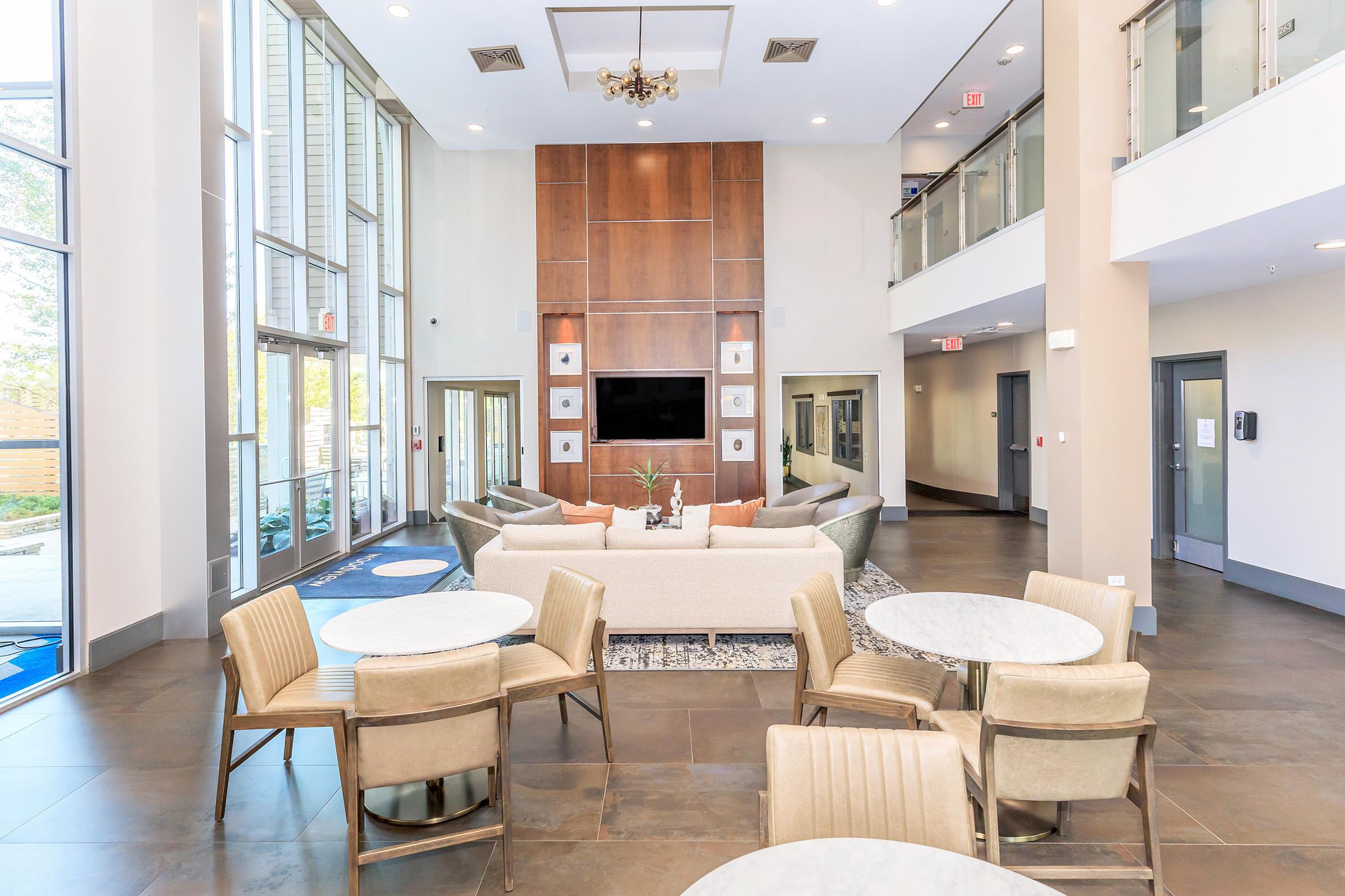 a living room filled with furniture and a large window