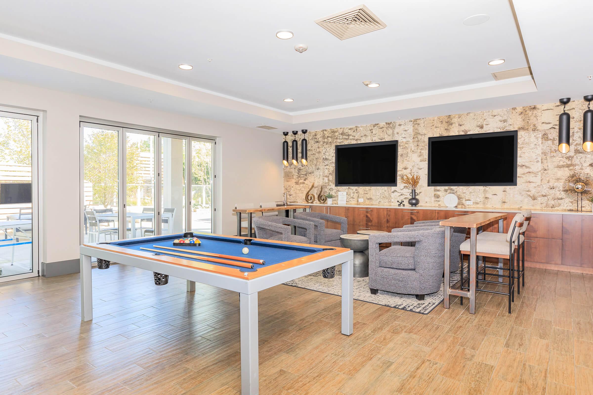 a living room filled with furniture and a large window