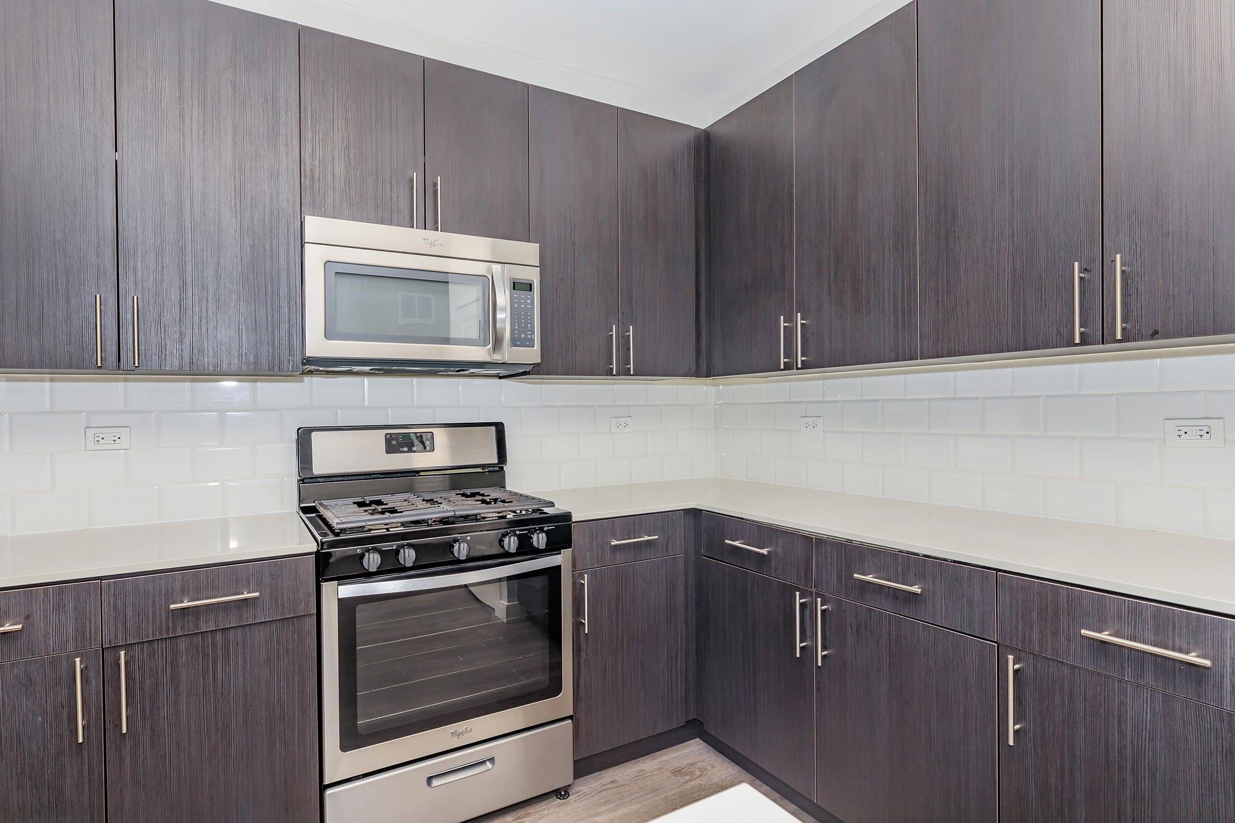 a kitchen with wooden cabinets and an oven