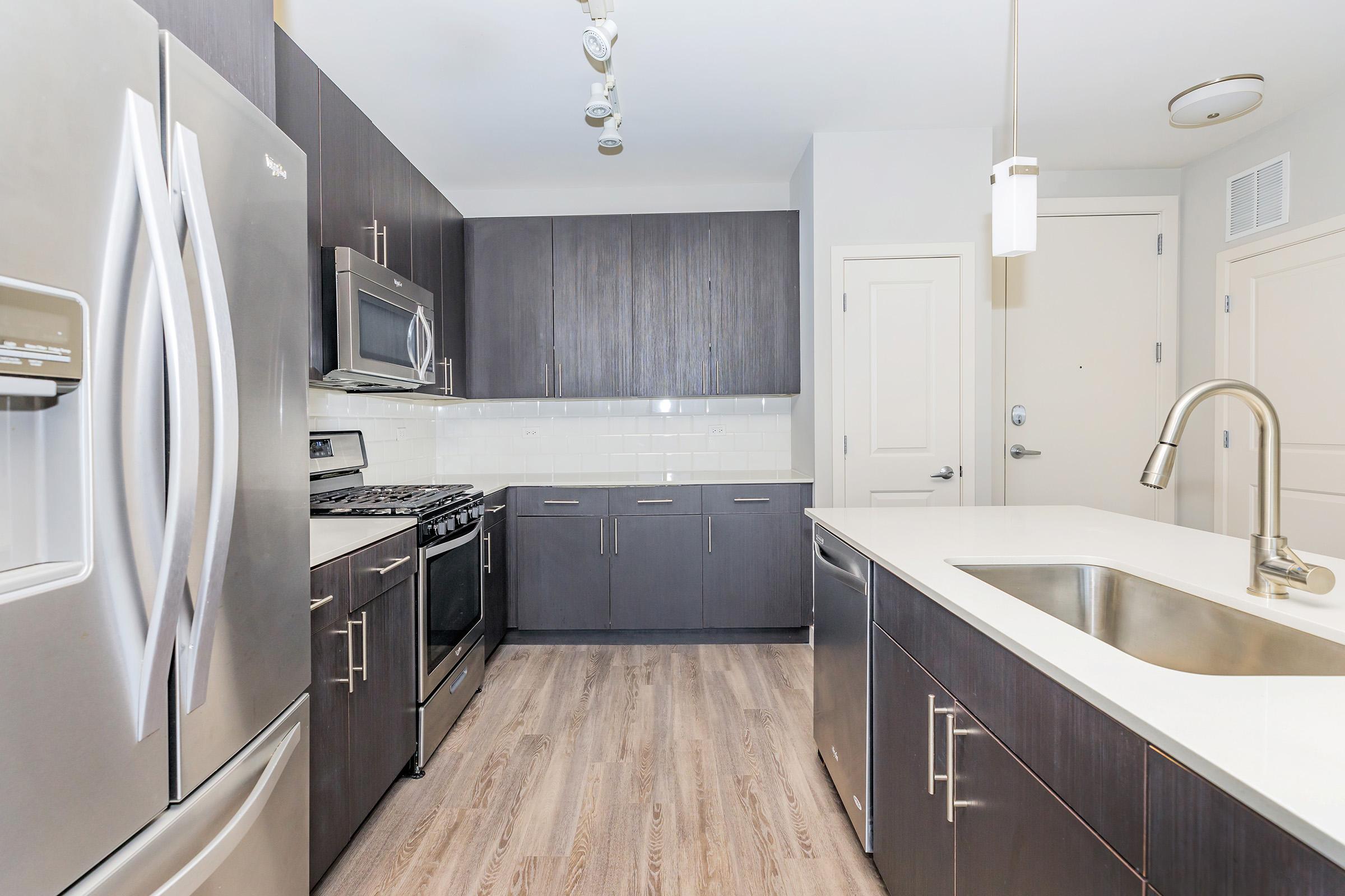 a large kitchen with stainless steel appliances