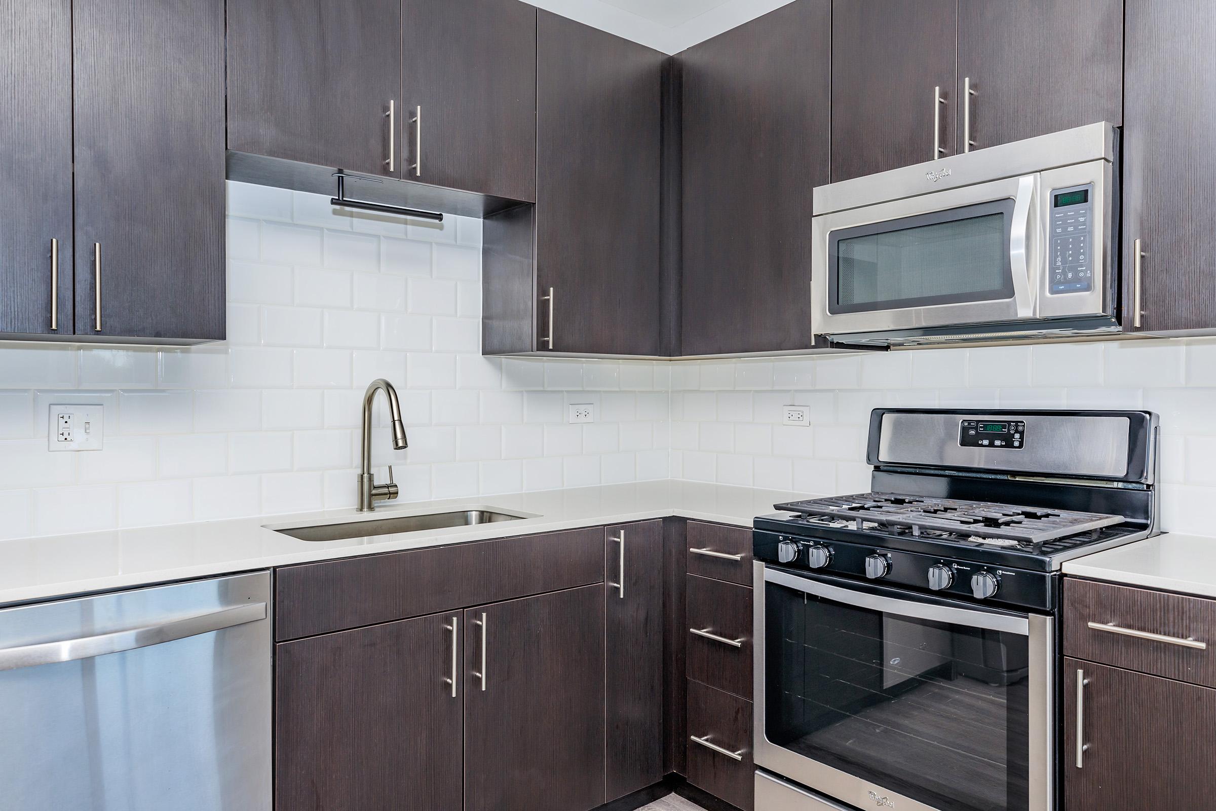 a stove top oven sitting inside of a kitchen