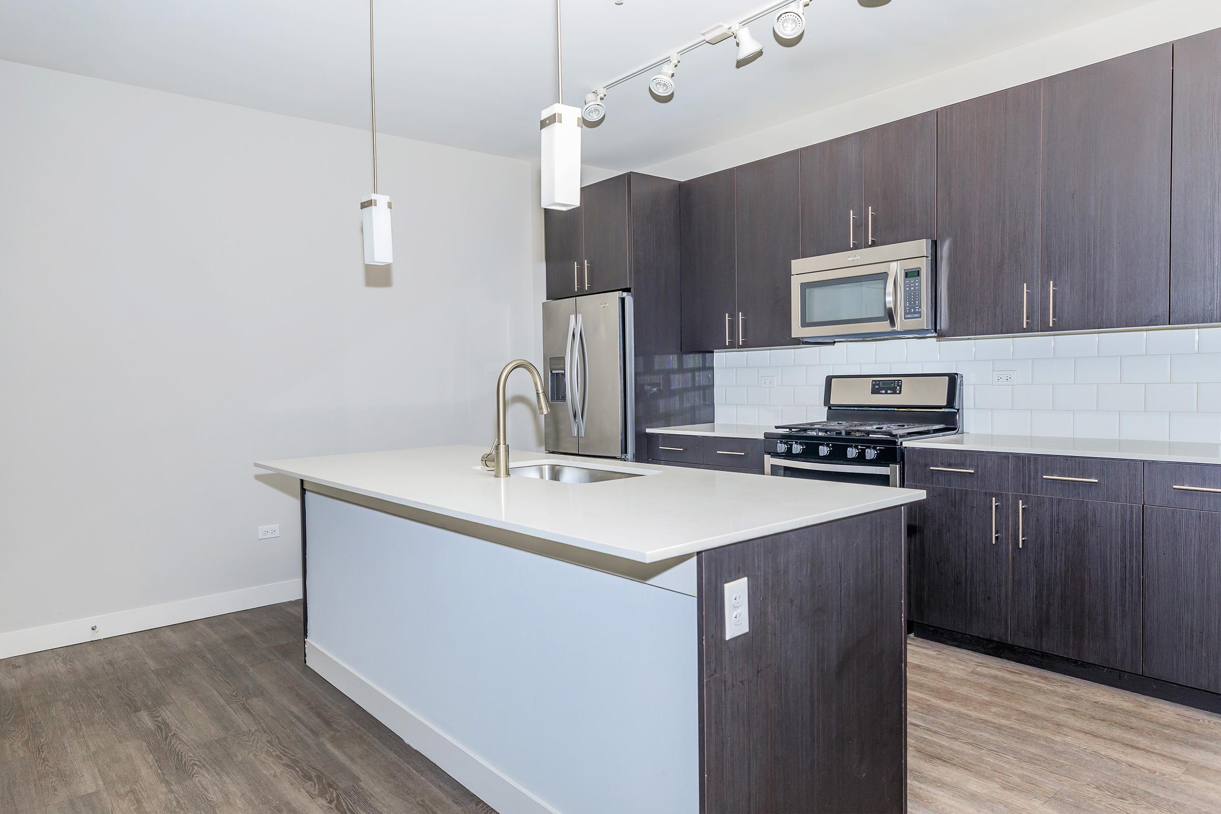 a kitchen with wooden cabinets and a sink