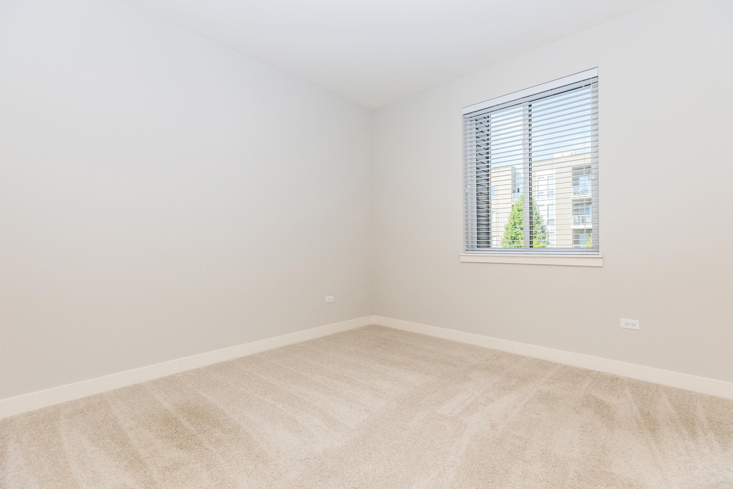 a bedroom with a large window