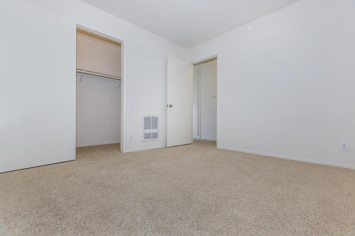 carpeted bedroom with an attached closet