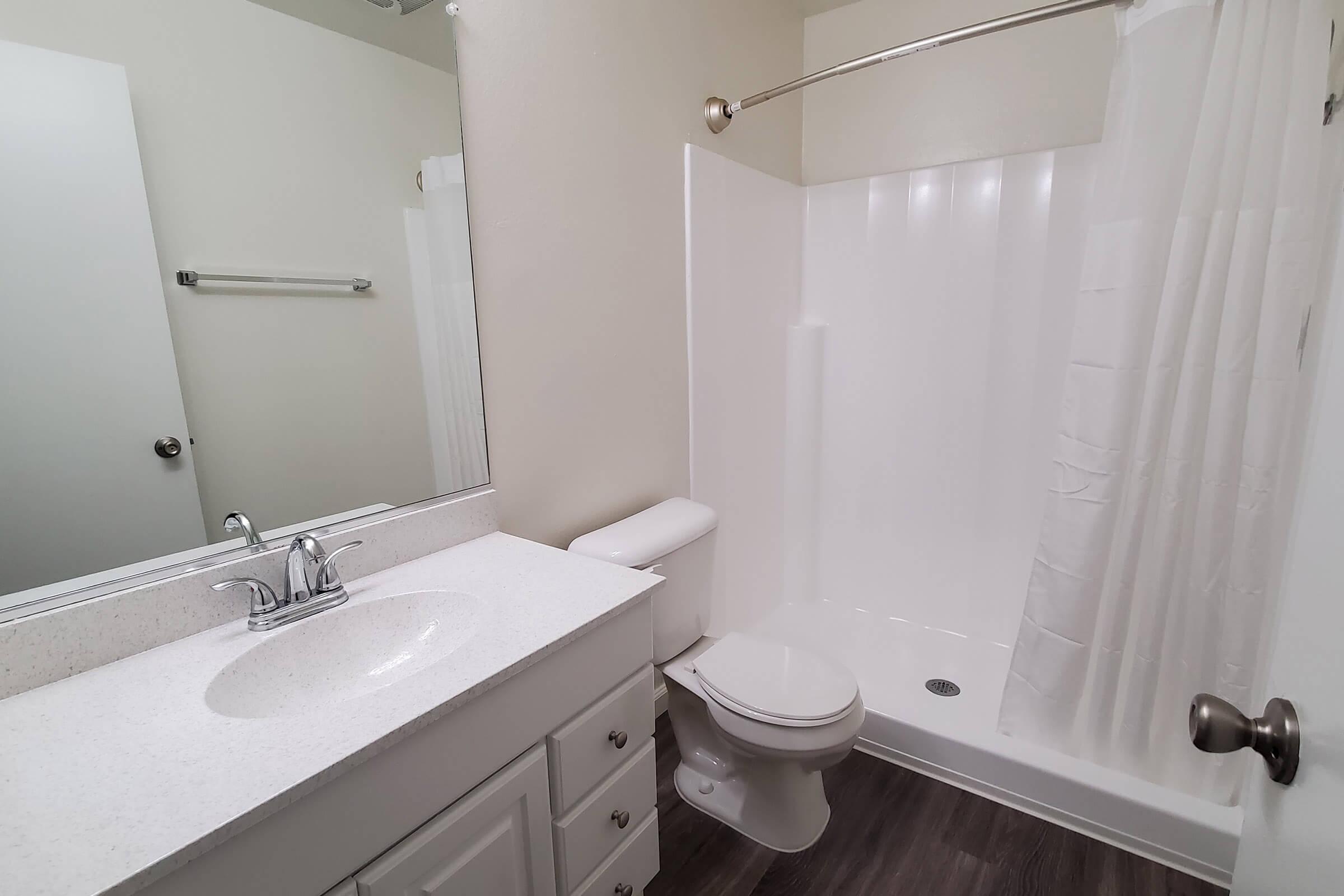 bathroom with a white shower curtain