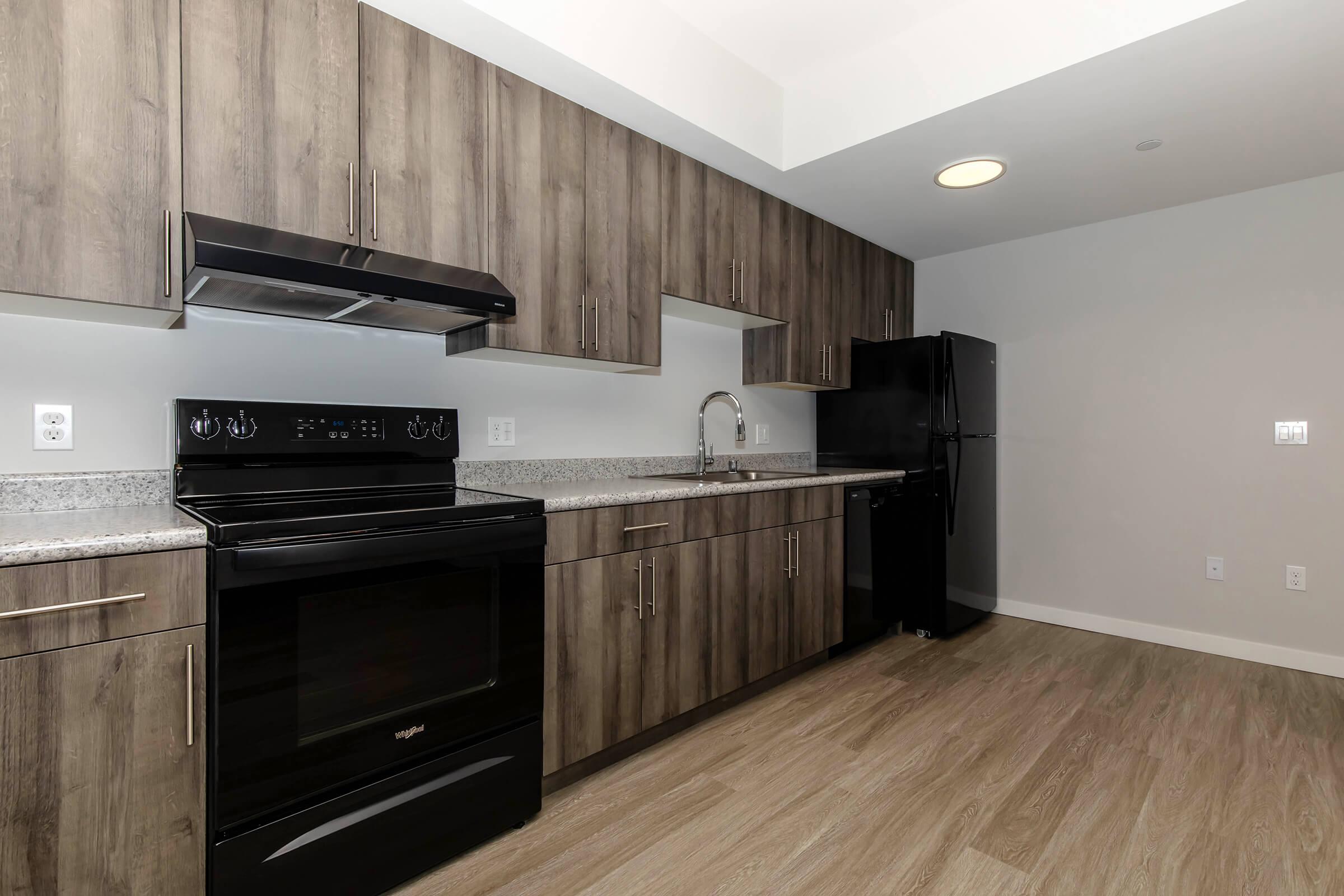 a stove top oven sitting inside of a kitchen