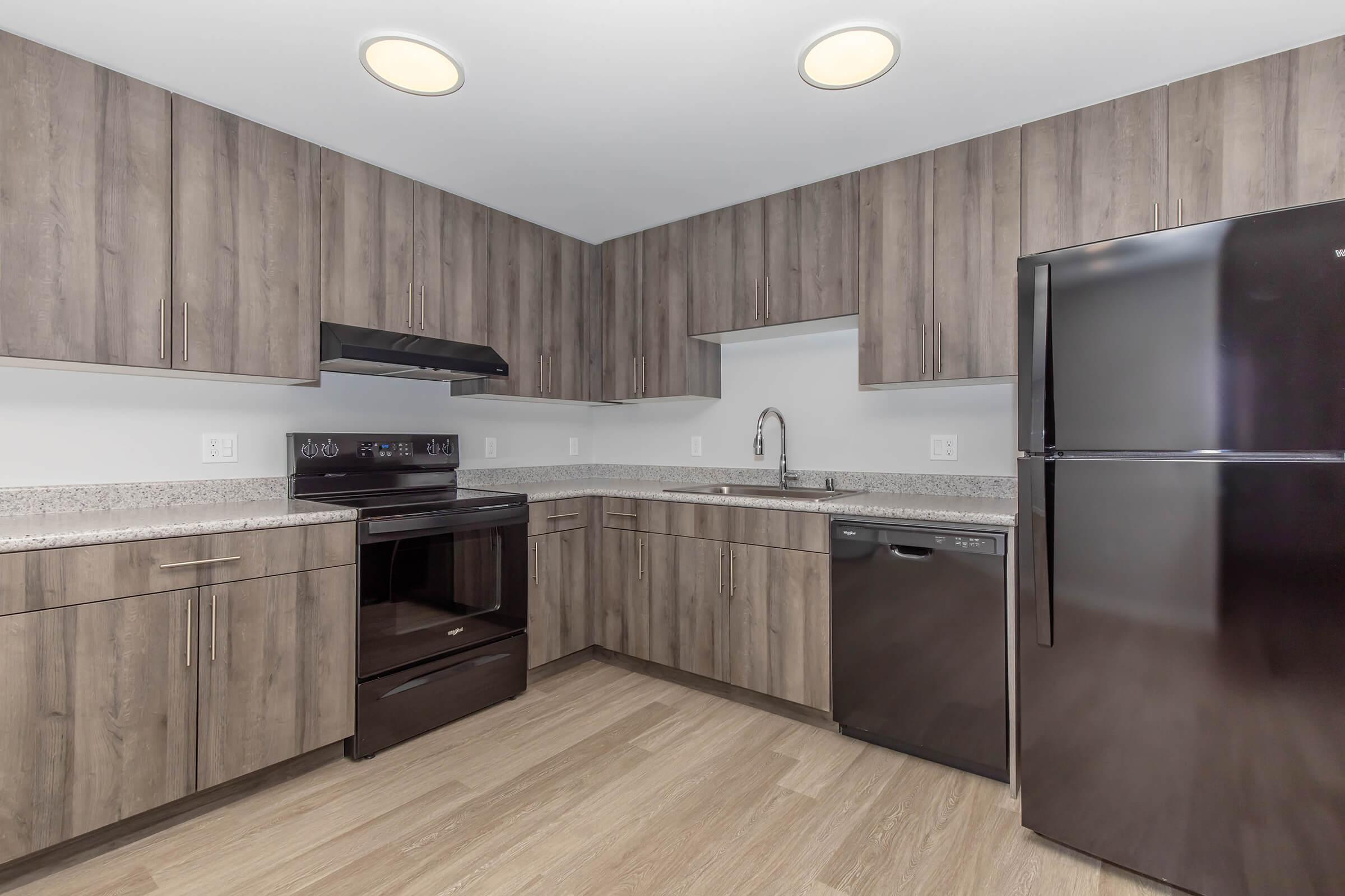 a kitchen with stainless steel appliances and wooden cabinets