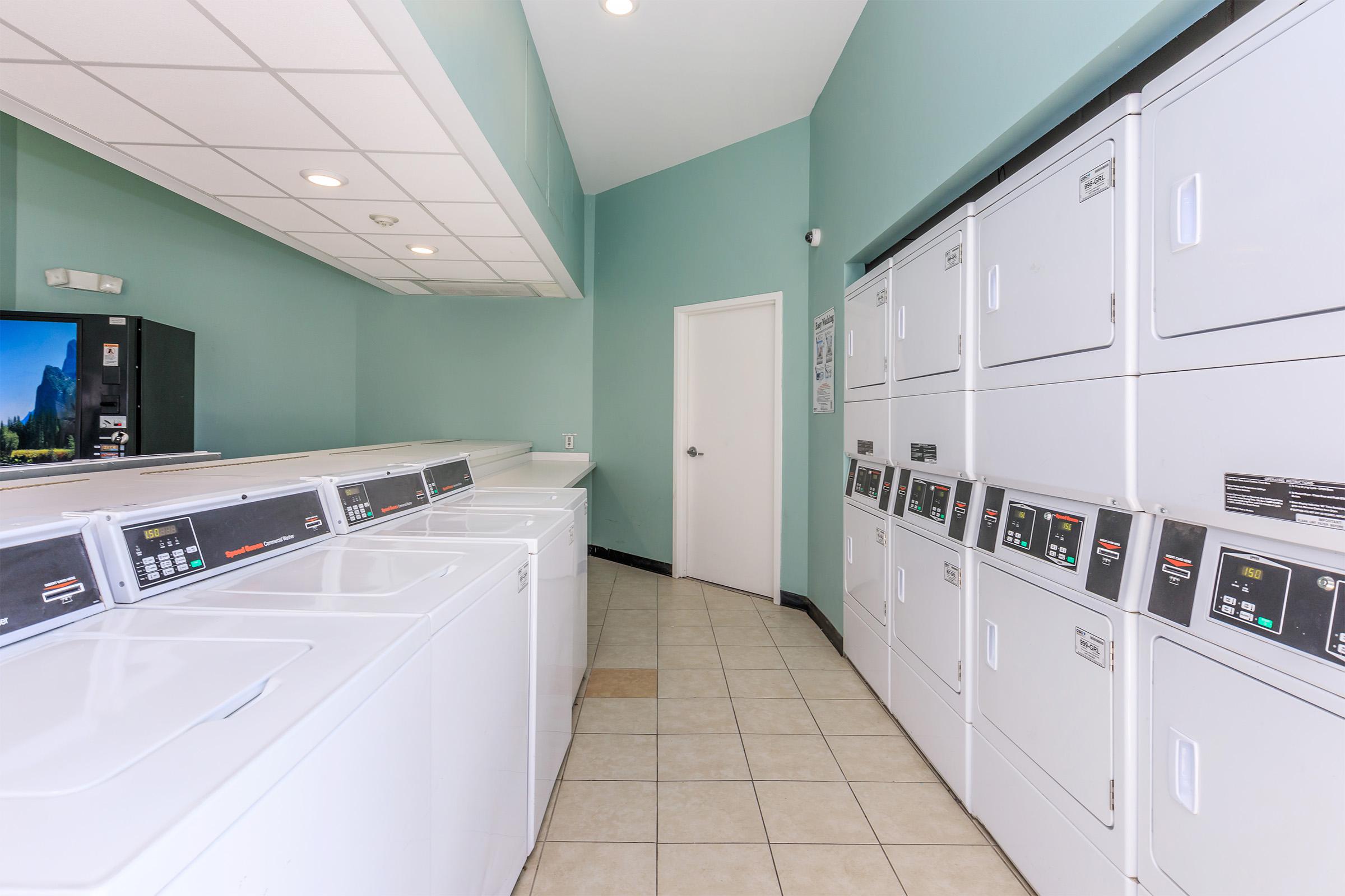 a large kitchen with white cabinets