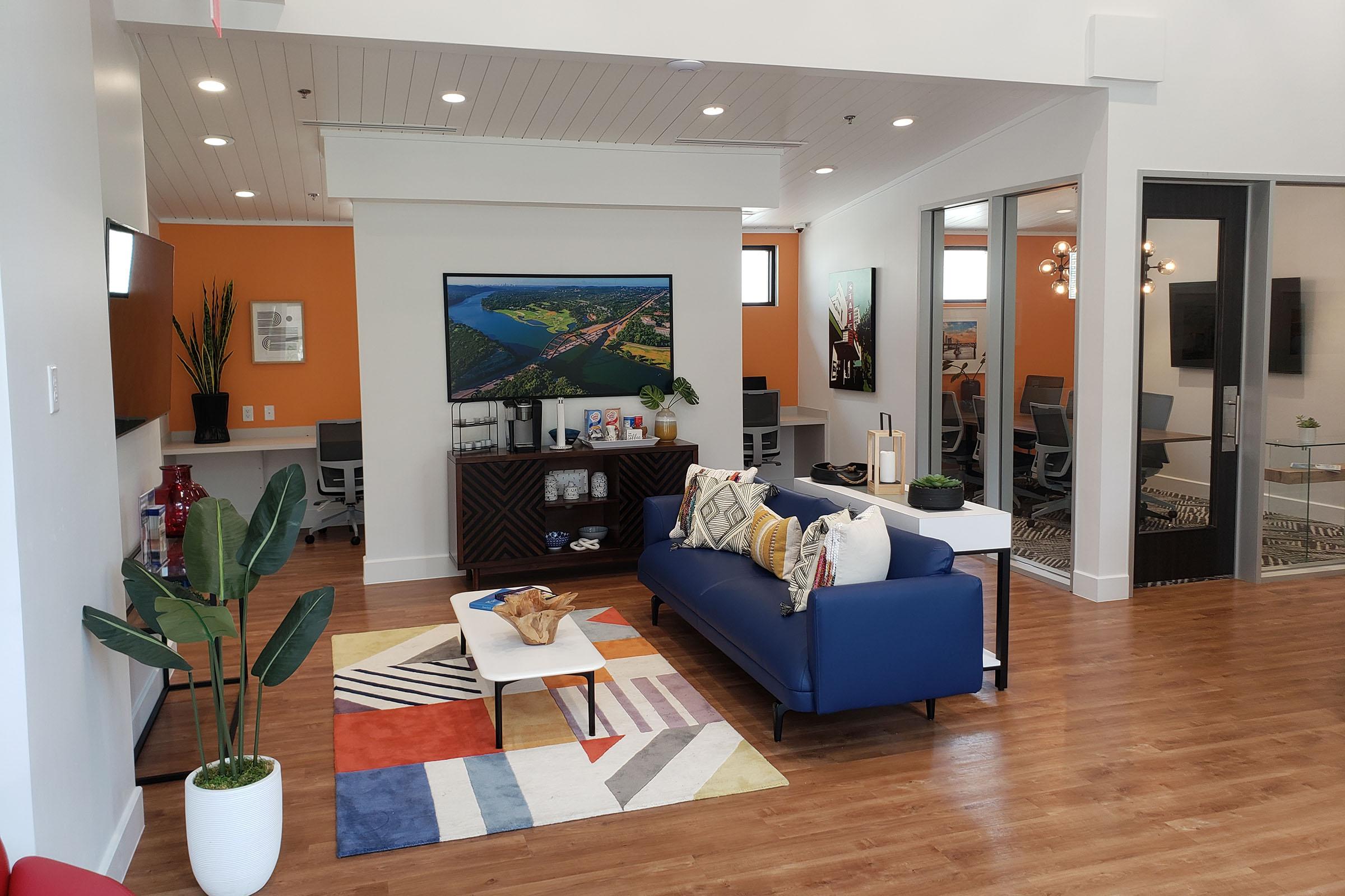 a living room filled with furniture and a large window