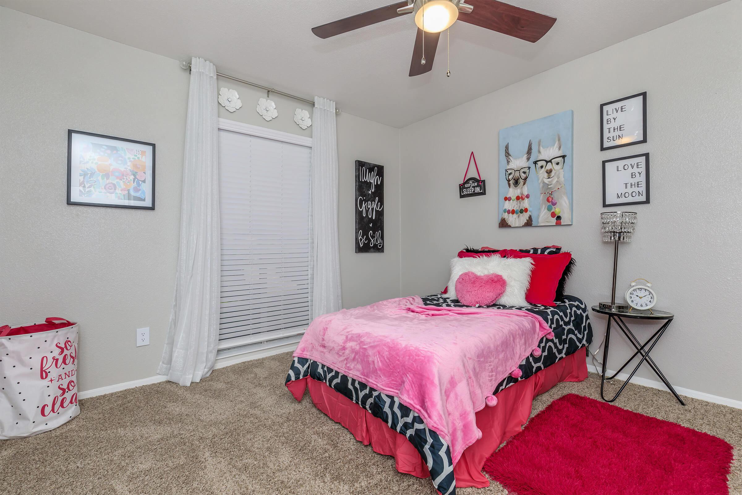 a bedroom with a red blanket