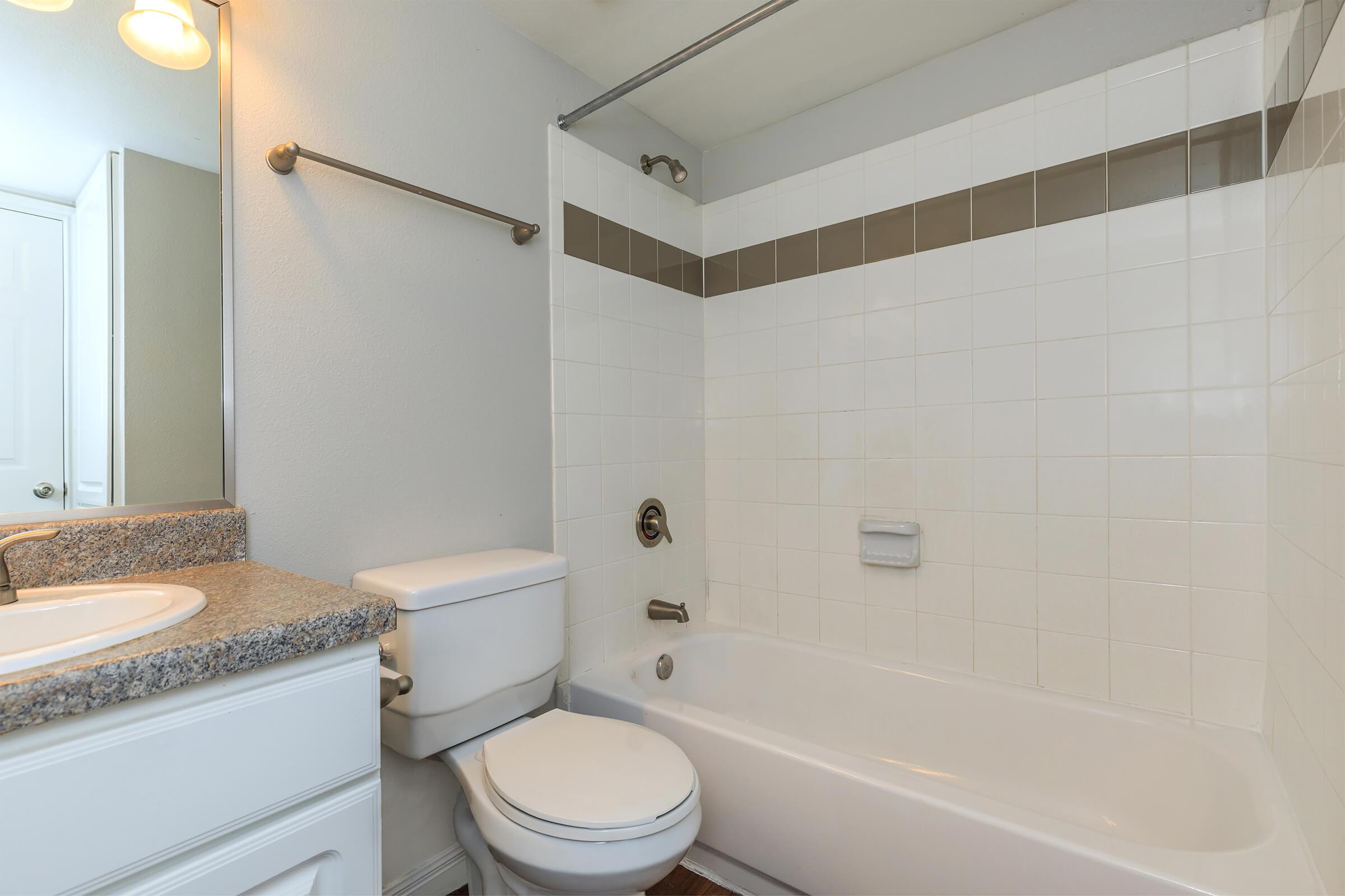 a white tub sitting next to a sink