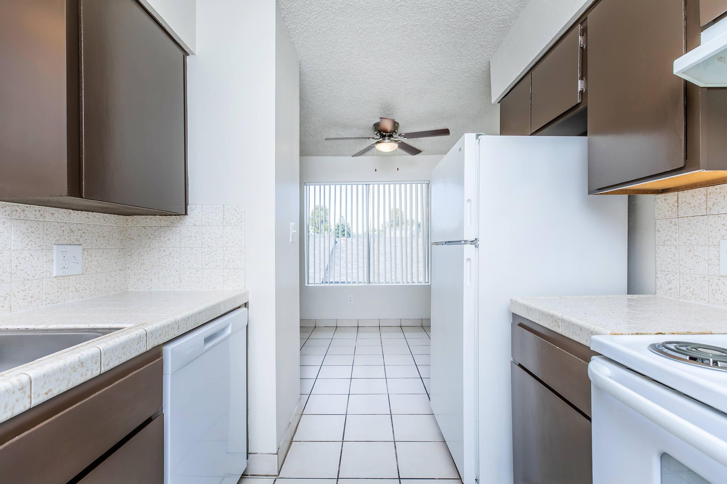 a kitchen with a sink and a mirror