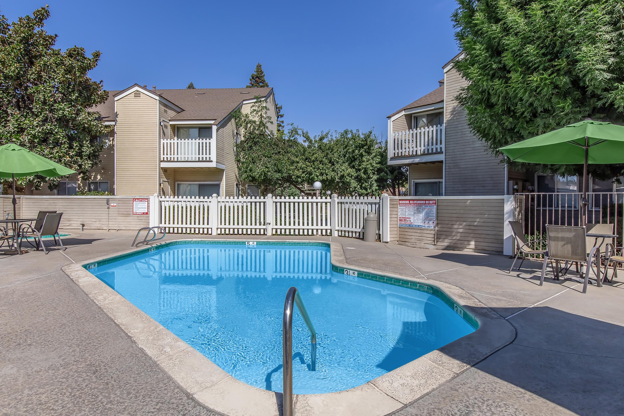 a house with a pool in front of a building