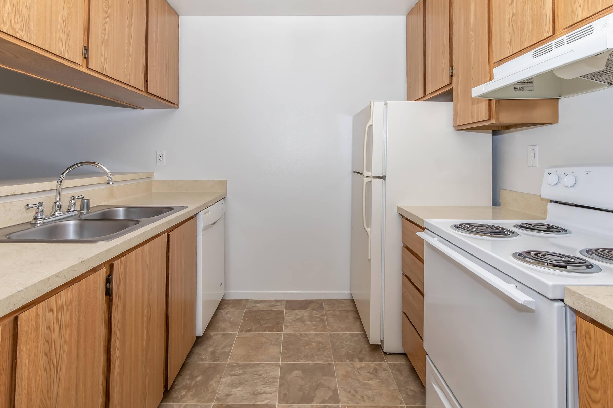 a kitchen with a stove sink and refrigerator