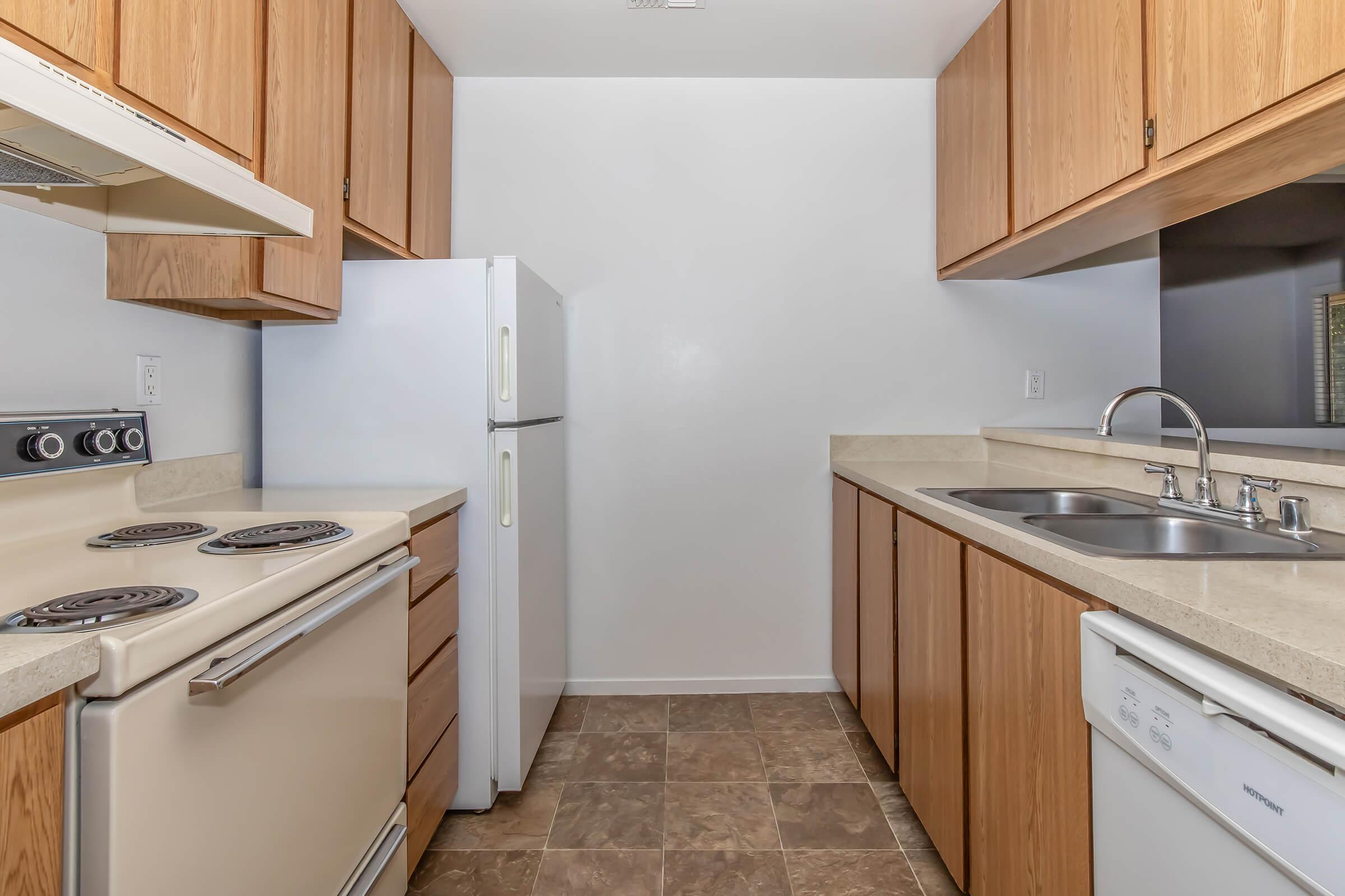 a kitchen with a stove sink and refrigerator