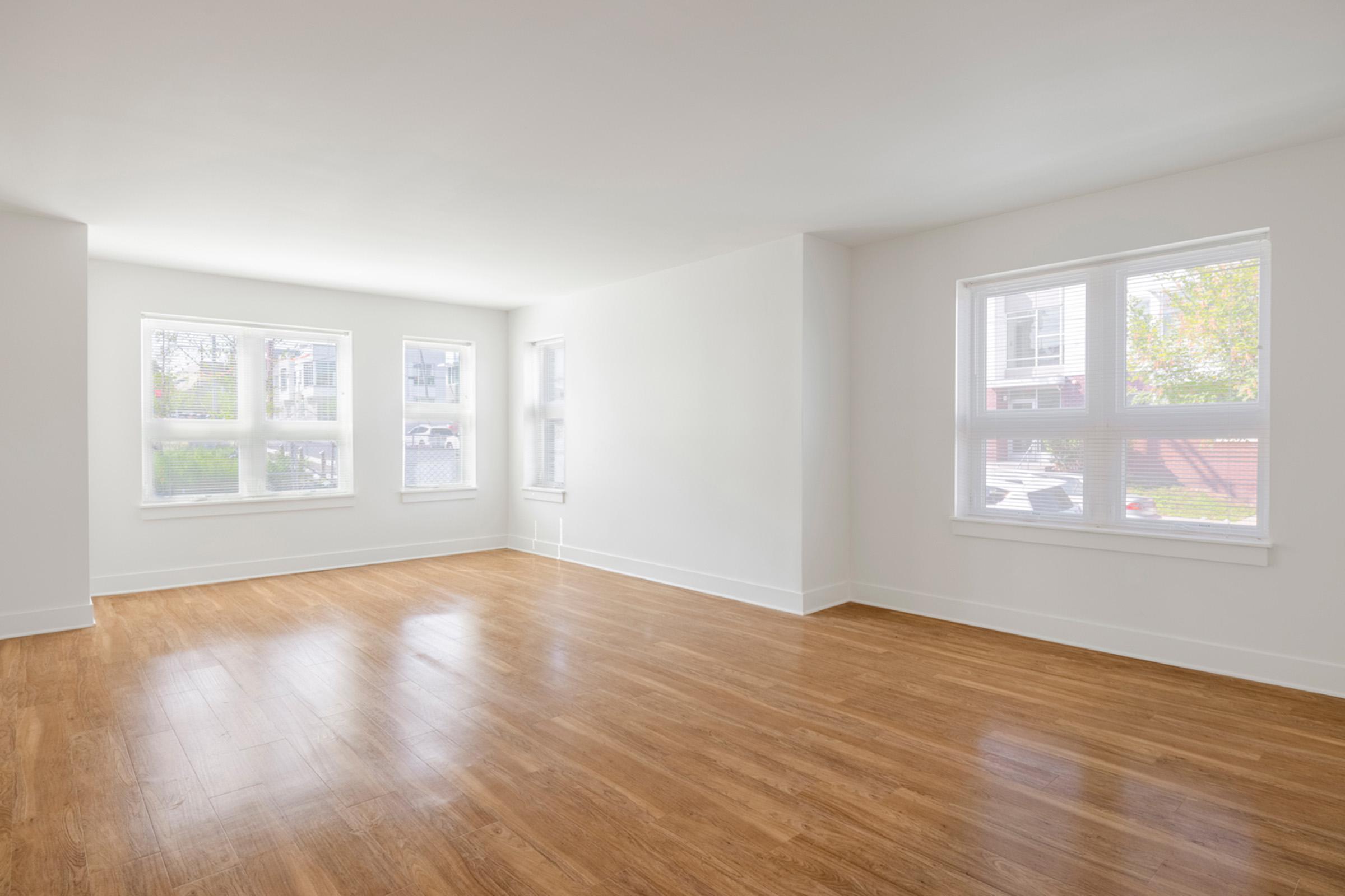 a close up of a hard wood floor next to a window