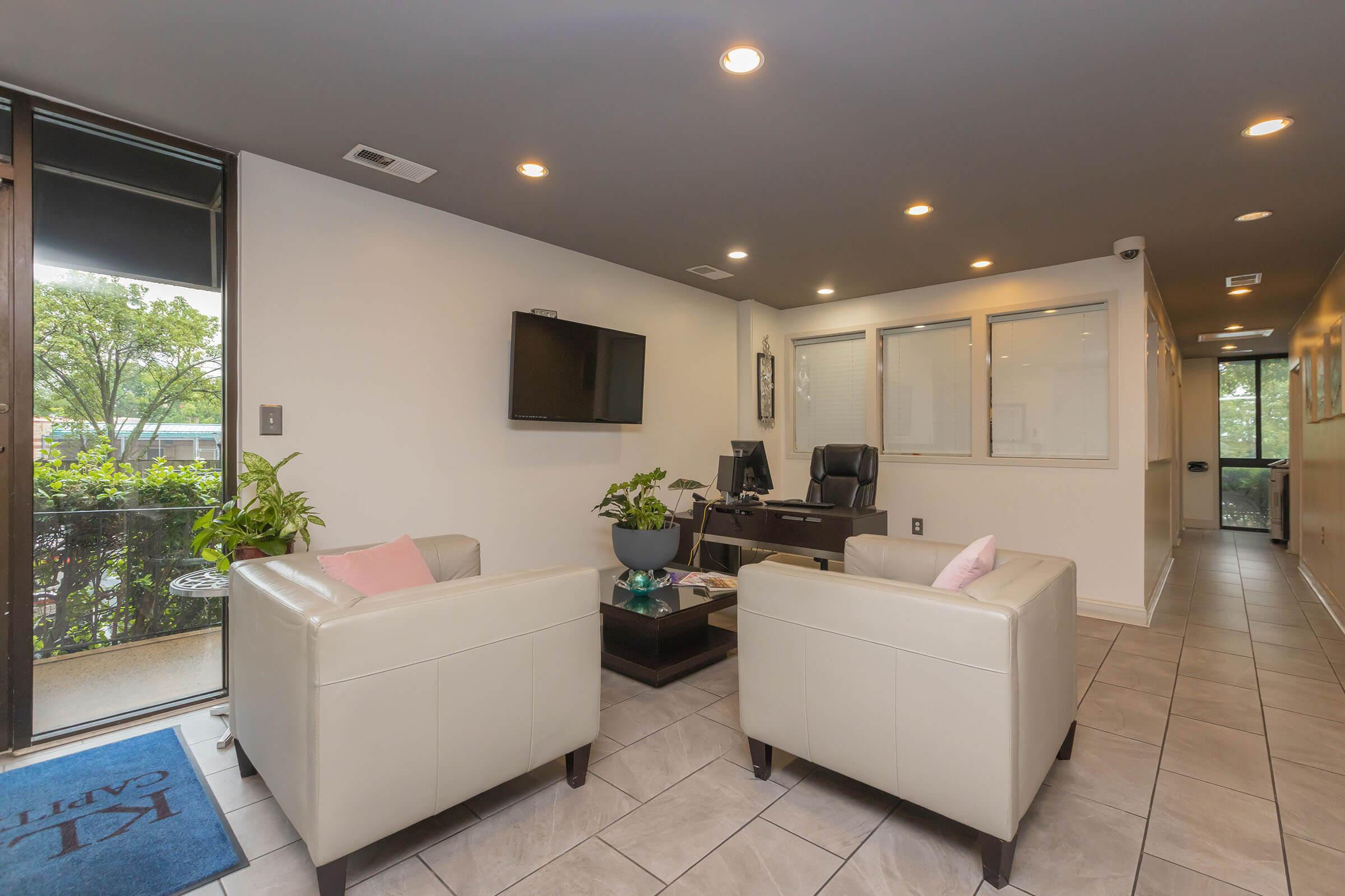 a living room filled with furniture and a large window