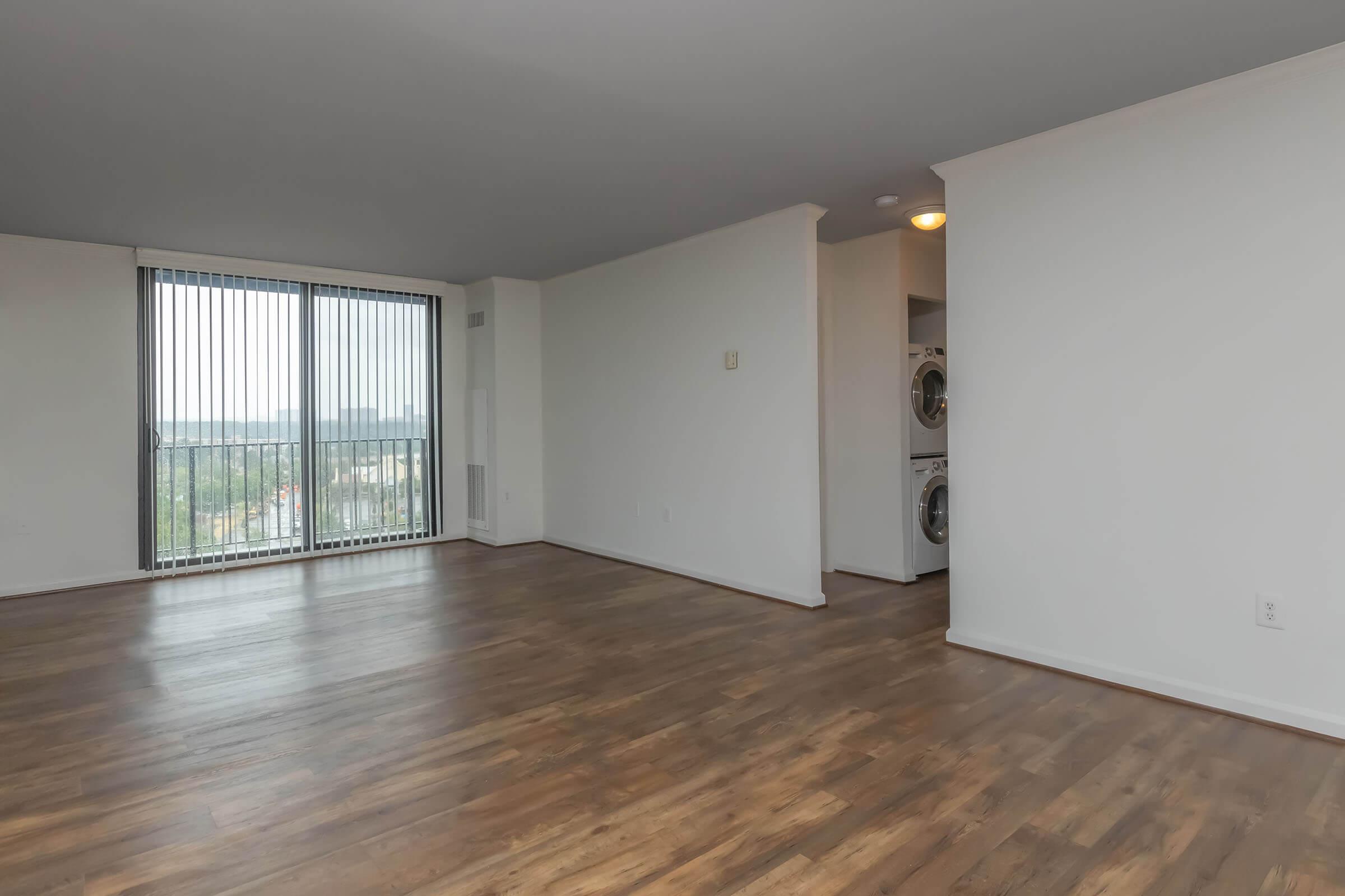 a large empty room with a wood floor