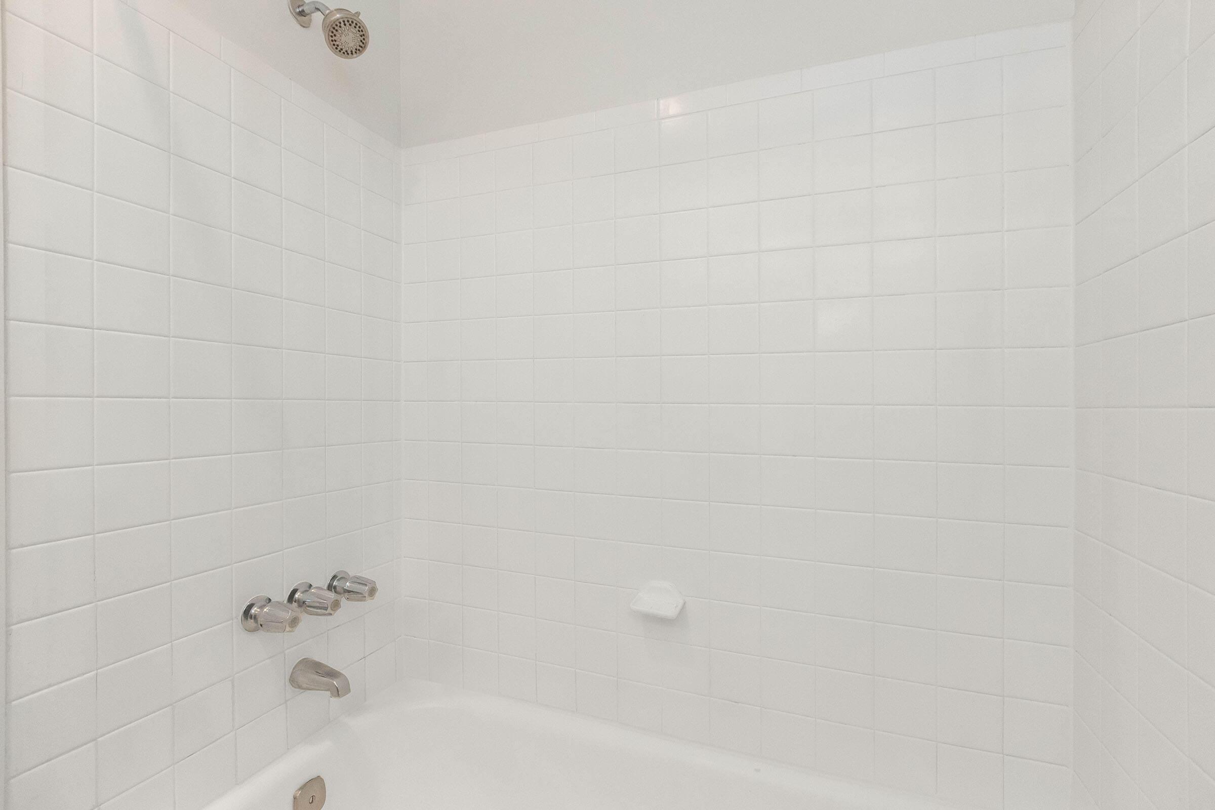 a close up of a sink in a tiled room